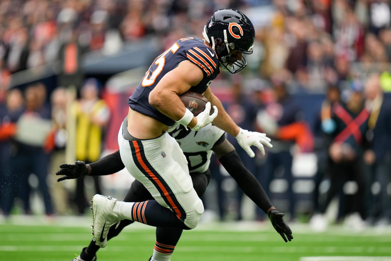 Chicago Bears tight end Cole Kmet (85) breaks through to score the first touch down in the first quarter of an NFL football game at the Tottenham Hotspur stadium between the Jacksonville Jaguars and Chicago Bears in London, Sunday, Oct. 13, 2024. (AP Photo/Alastair Grant)