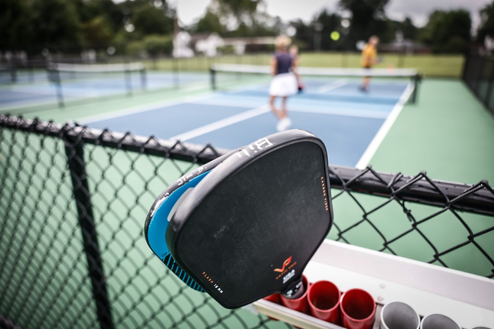 People play pickleball using paddles at the new courts at J.F. Kennedy Park in Kettering. JIM NOELKER/STAFF