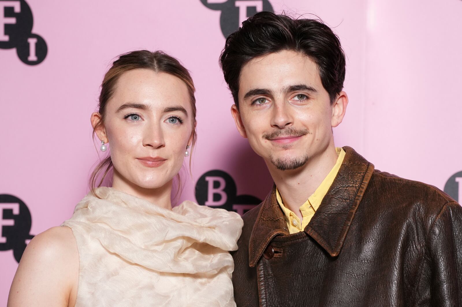 Saoirse Ronan, left, and Timothee Chalamet pose for photographers upon arrival at the photo call for an 'In Conversation' event at the BFI Southbank, on Wednesday, Dec. 18, 2024, in London. (Photo by Scott A Garfitt/Invision/AP)