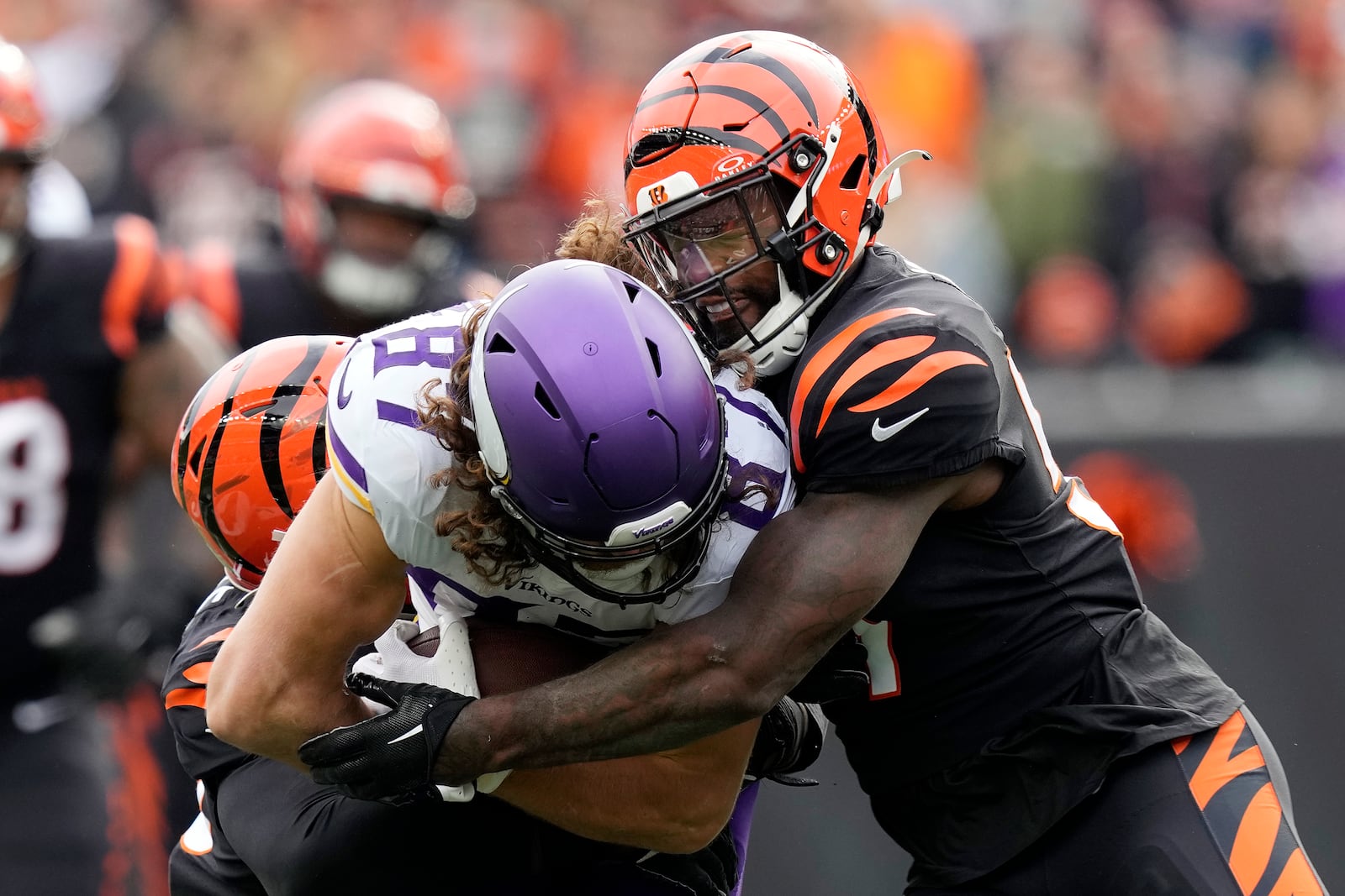 Minnesota Vikings tight end T.J. Hockenson (87) is tackled by Cincinnati Bengals linebacker Germaine Pratt, right, during the first half of an NFL football game Saturday, Dec. 16, 2023, in Cincinnati. (AP Photo/Carolyn Kaster)