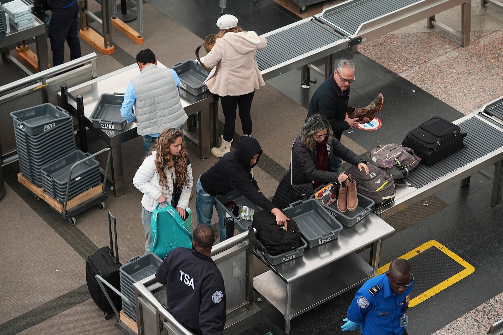 Travellers queue up to pass through the south security checkpoint in the main terminal of Denver International Airport Tuesday, Dec. 24, 2024, in Denver. (AP Photo/David Zalubowski)