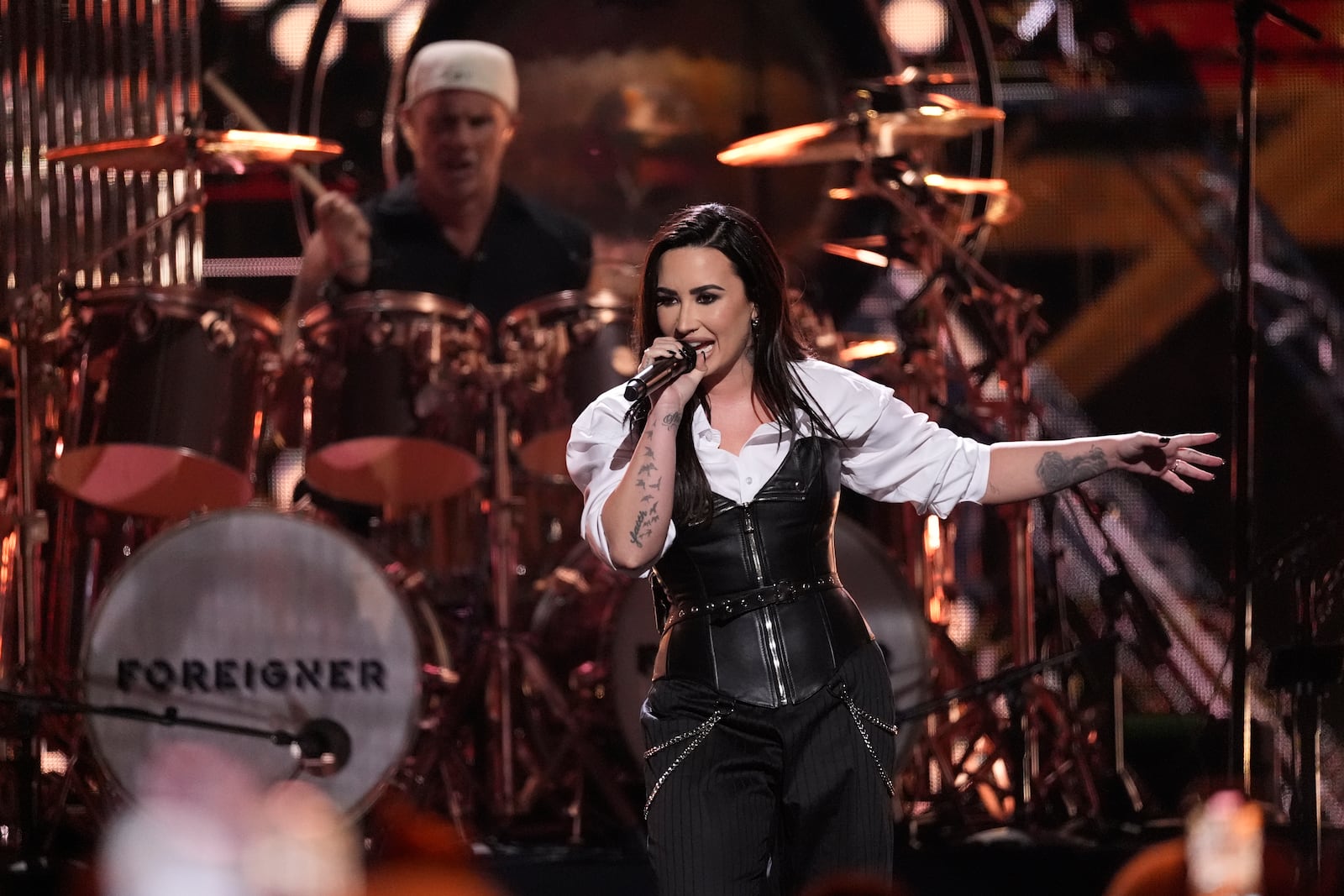 Chad Smith, left, on drum, and Demi Lovato perform during the 39th Annual Rock & Roll Hall of Fame Induction Ceremony on Saturday, Oct. 19, 2024, at Rocket Mortgage FieldHouse in Cleveland. (AP Photo/Chris Pizzello)