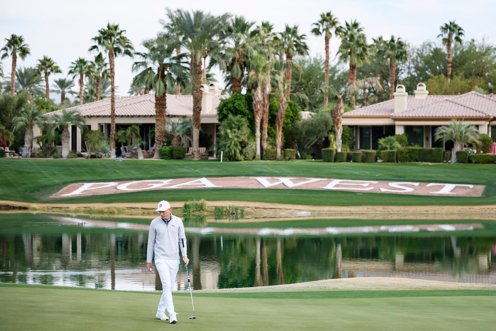 Matti Schmid walks along the 18th green at the Nicklaus Tournament Course during the first round of the American Express golf tournament in La Quinta, Calif., Thursday, Jan. 16, 2025. (AP Photo/William Liang)