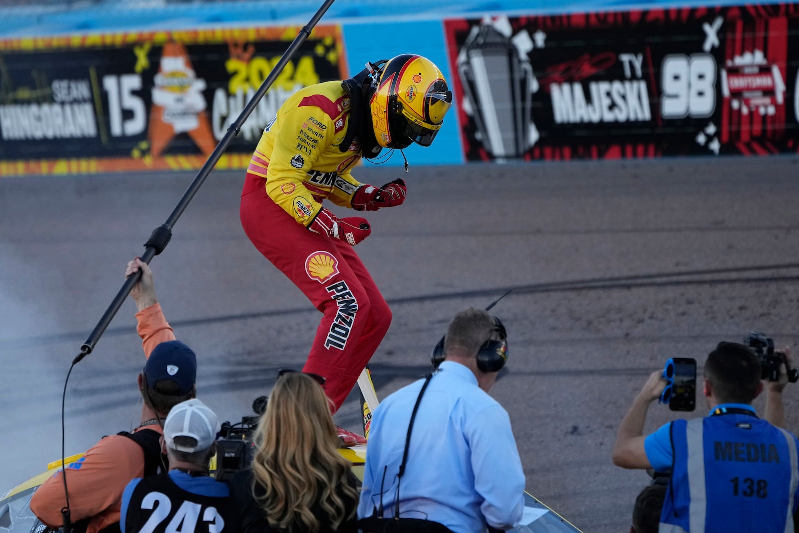 Joey Logano celebrates after winning a NASCAR Cup Series Championship auto race for the championship at Phoenix Raceway, Sunday, Nov. 10, 2024, in Avondale, Ariz. (AP Photo/John Locher)