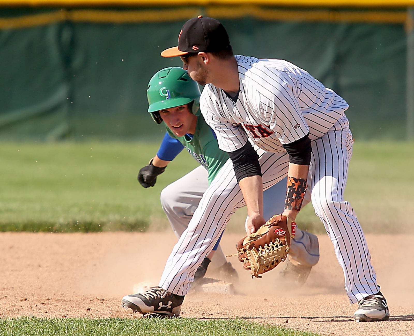 Chaminade Julienne’s Mark Barhorst looks back at Waynesville second baseman Cory Clark after stealing second base during their Division II regional semifinal at Mason on Friday. CONTRIBUTED PHOTO BY E.L. HUBBARD