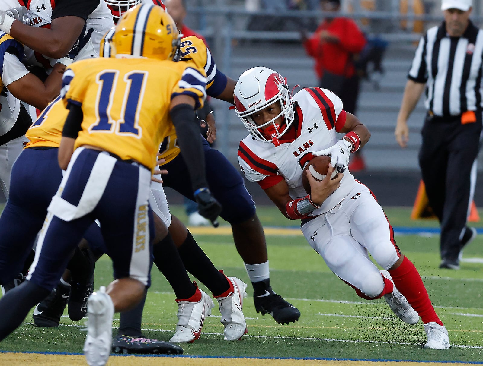 Trotwood's Deontai Gholson looks for an opening in the Springfield defense as he carries the ball. BILL LACKEY/STAFF