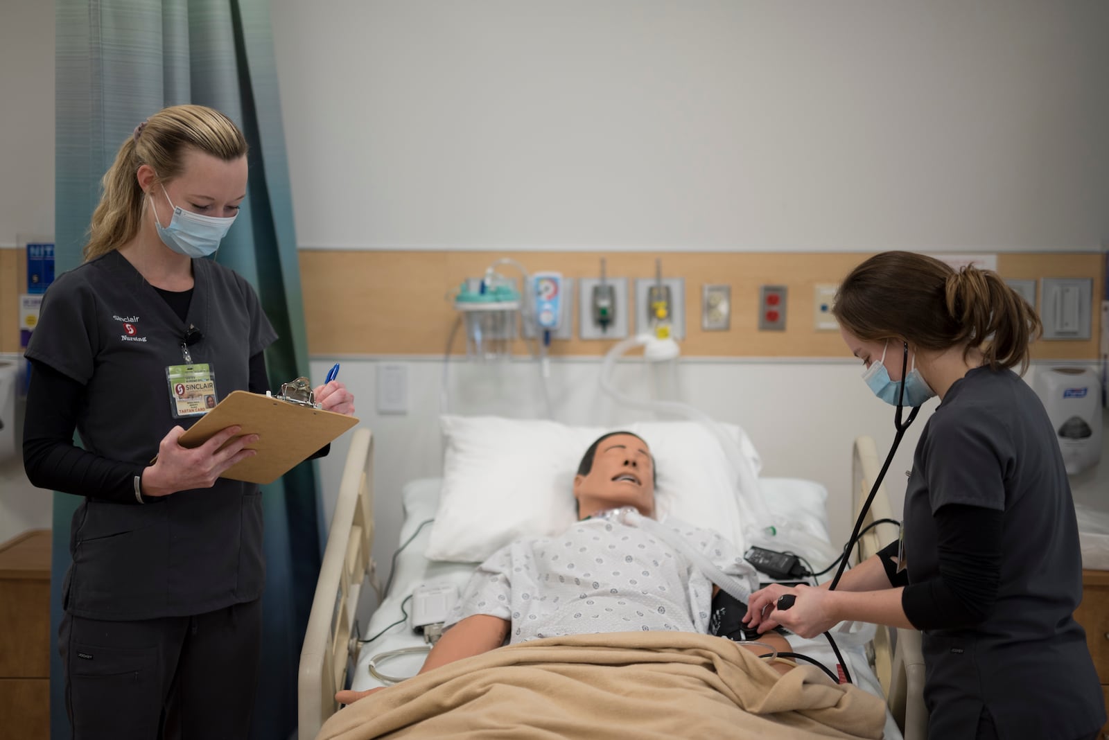 Sinclair nursing students work in a classroom setting. Sinclair is adding 18 new spots per year to its program. Courtesy of Sinclair Community College.