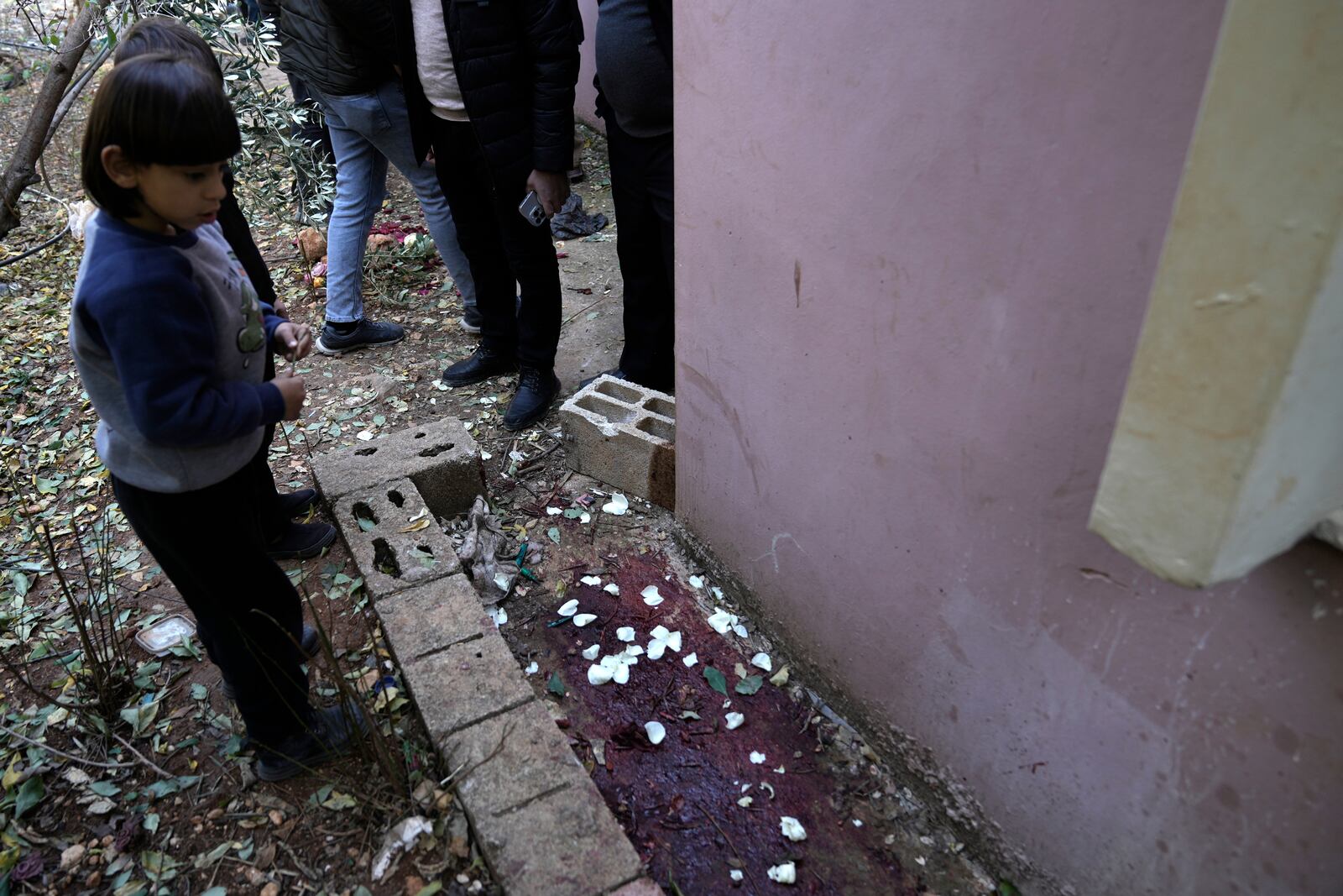 A child looks at blood at the site where Jaafar Dababsah, a Palestinian Hamas commander was killed in a raid by Israeli forces, in the village of Talouza, near the West Bank city of Nablus, Tuesday, Jan. 7, 2025. (AP Photo/Majdi Mohammed)