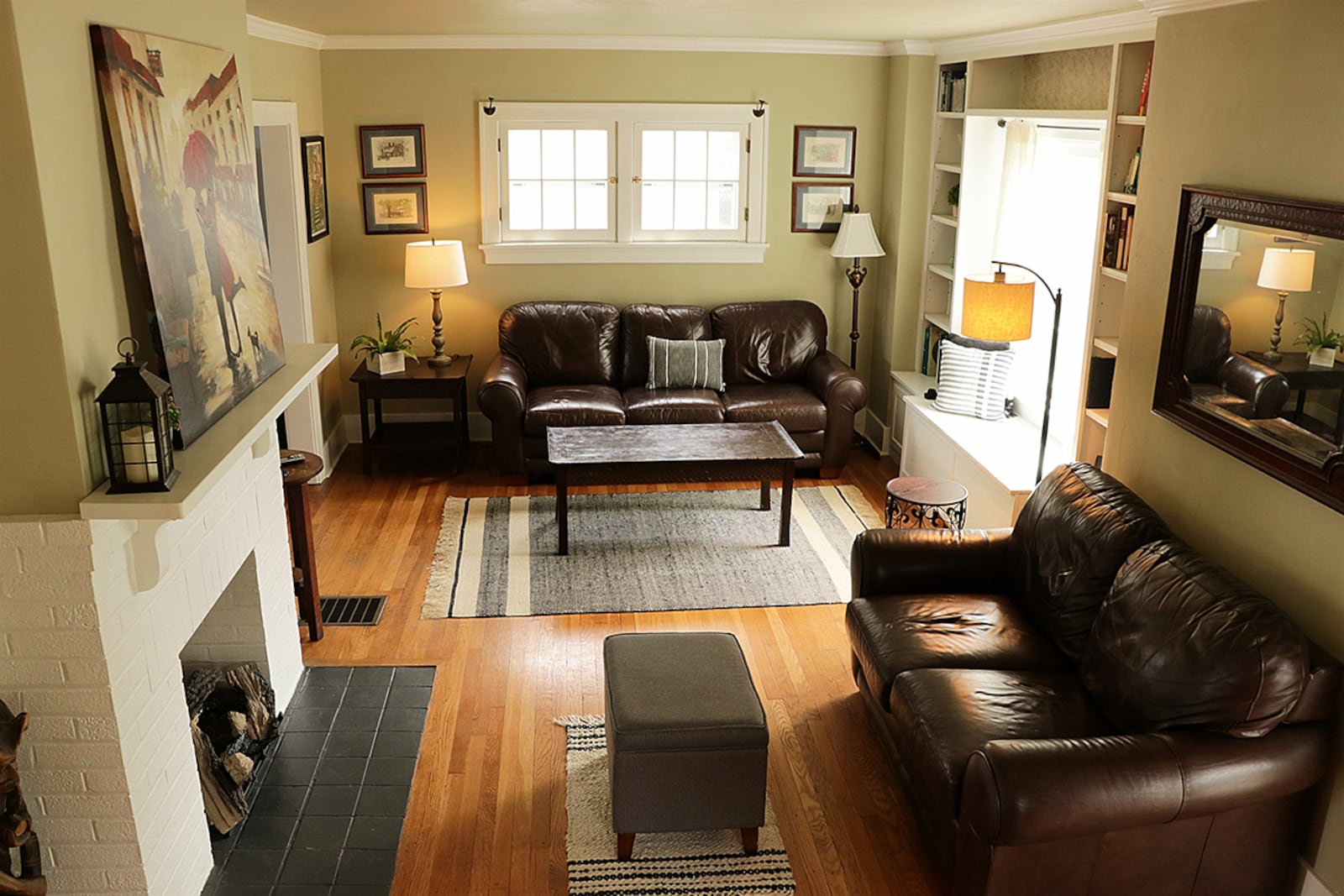 A front porch protects the formal entry with its red door that opens directly into the living room. Original windows that keep the historical charm of the home built in 1927 have vinyl storms for added protection. Across the living room is a gas fireplace with new remote starter. CONTRIBUTED PHOTO BY KATHY TYLER