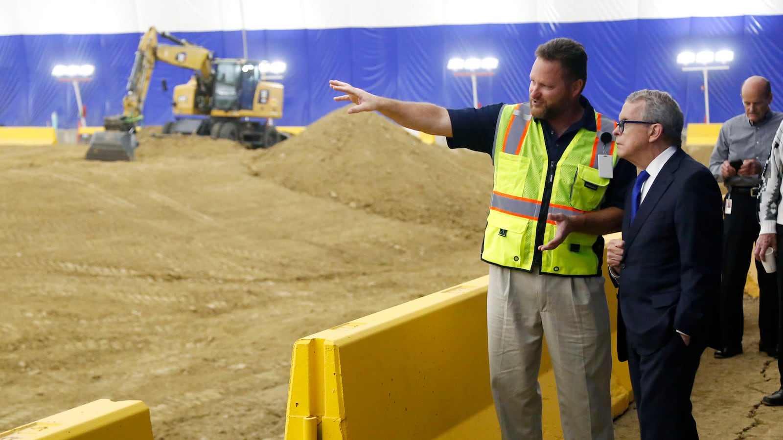 Ohio Gov. Mike Dewine, right, in a 2019 visit with a Trimble engineering manager, inside the company’s Dayton Development Dome, a research facility that allows equipment testing to take place no matter what the weather. TY GREENLEES / STAFF