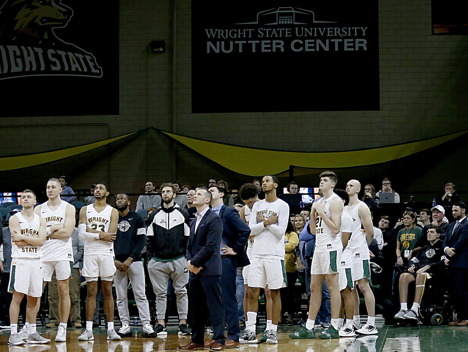 Ryan Custer sits in his wheelchair with his team as a video of him talking about his experience and saying thanks is shown after Wright State’s game against IUPUI at the Nutter Center in Fairborn on Sunday, Feb. 16, 2020. Contributed photo by E.L. Hubbard