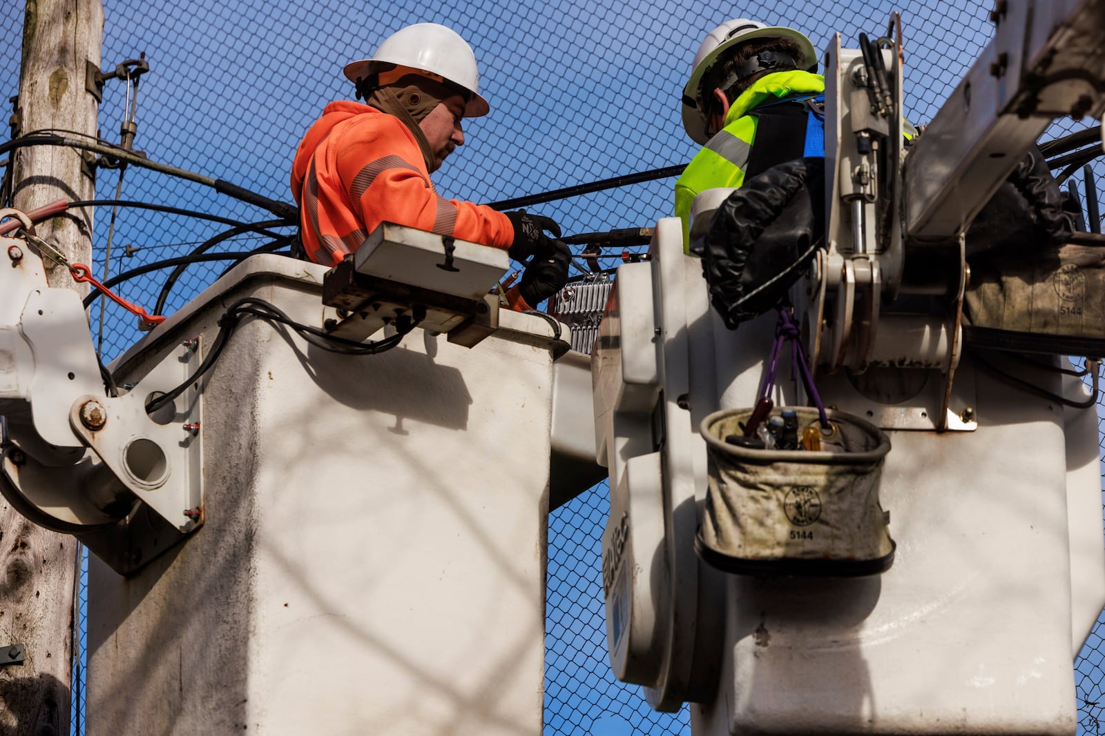 Comcast crews work in off Renton-Maple Valley Road in Renton, Wash., Wednesday, Nov. 20, 2024. (Erika Schultz/The Seattle Times via AP)