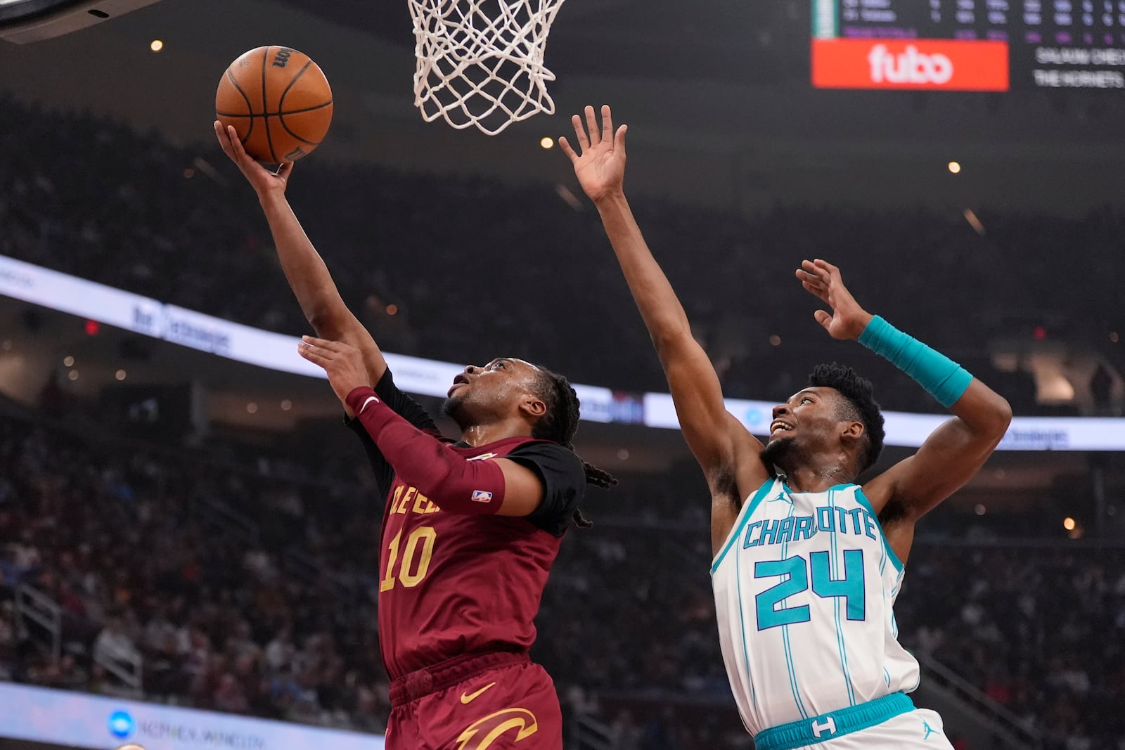 Cleveland Cavaliers guard Darius Garland (10) shoots in front of Charlotte Hornets forward Brandon Miller (24) in the first half of an NBA basketball game, Sunday, Jan. 5, 2025, in Cleveland. (AP Photo/Sue Ogrocki)