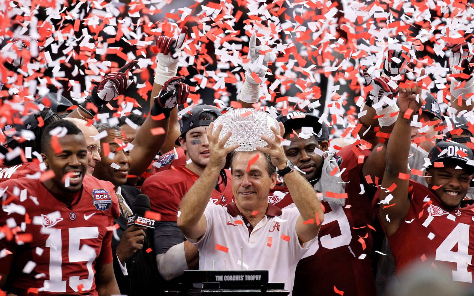 FILE - Alabama head coach Nick Saban celebrates with his team after the BCS National Championship college football game against LSU, in New Orleans, Jan. 9, 2012. (AP Photo/Gerald Herbert, File)