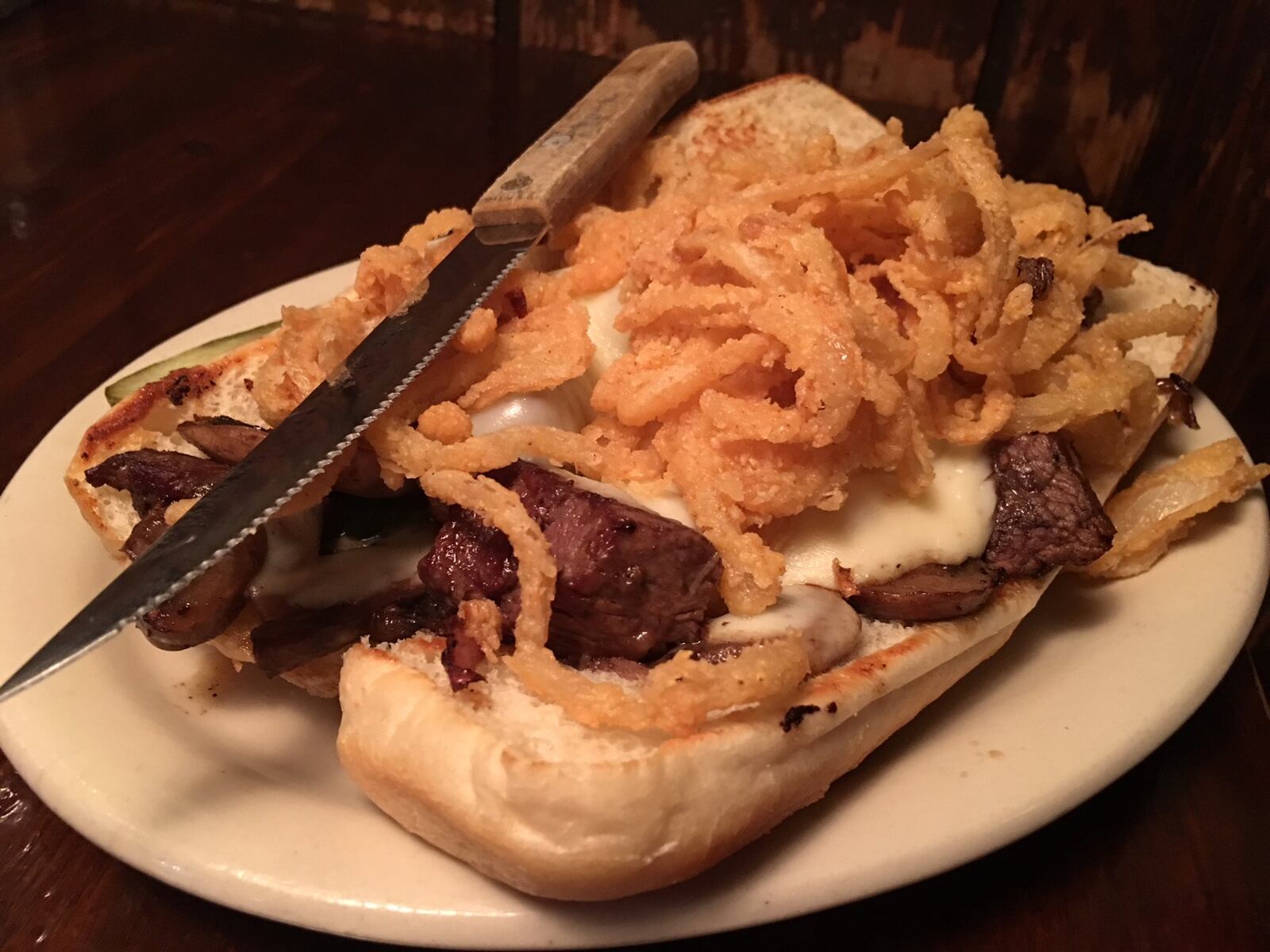 The Buckhorn Tavern’s Bistro Filet ($11.99) is a rich creation of sliced filet mignon, grilled peppers and onions, mushrooms, provolone cheese on a toasted deli roll with garlic butter and topped with crispy fried onions. CONTRIBUTED PHOTO BY ALEXIS LARSEN