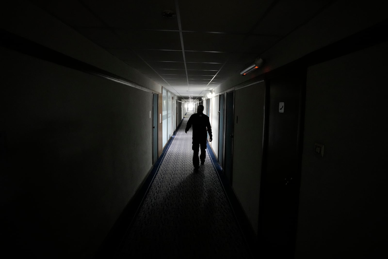 A security worker walks through Hotel Yugoslavia, once a symbol of progress in the former socialist state of Yugoslavia that broke apart in the 1990s and a favorite gathering place for local residents as well as world leaders, in Belgrade, Serbia, Thursday, Oct. 3, 2024. (AP Photo/Darko Vojinovic)