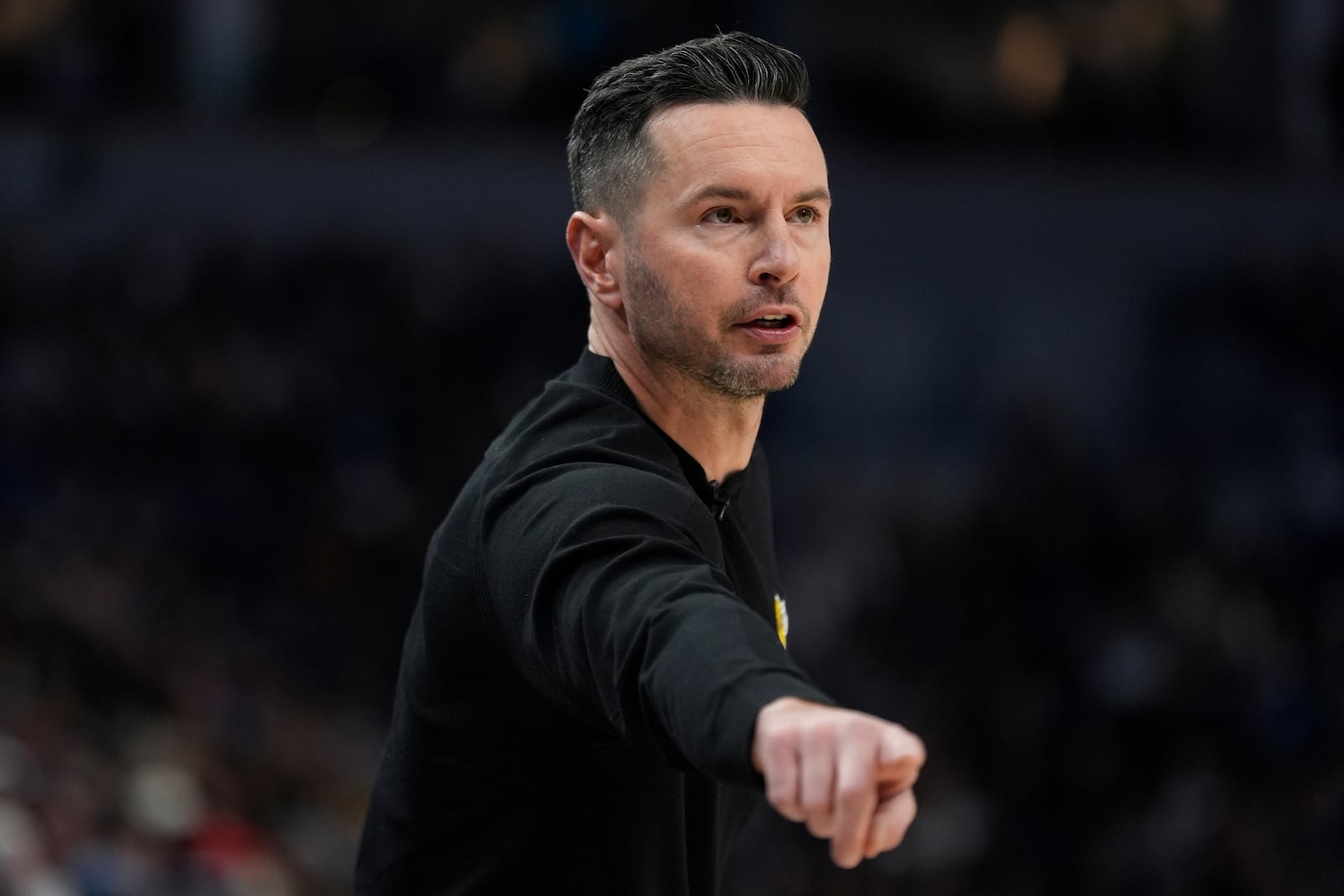 Los Angeles Lakers head coach JJ Redick points during the first half of an NBA basketball game against the Minnesota Timberwolves, Monday, Dec. 2, 2024, in Minneapolis. (AP Photo/Abbie Parr)