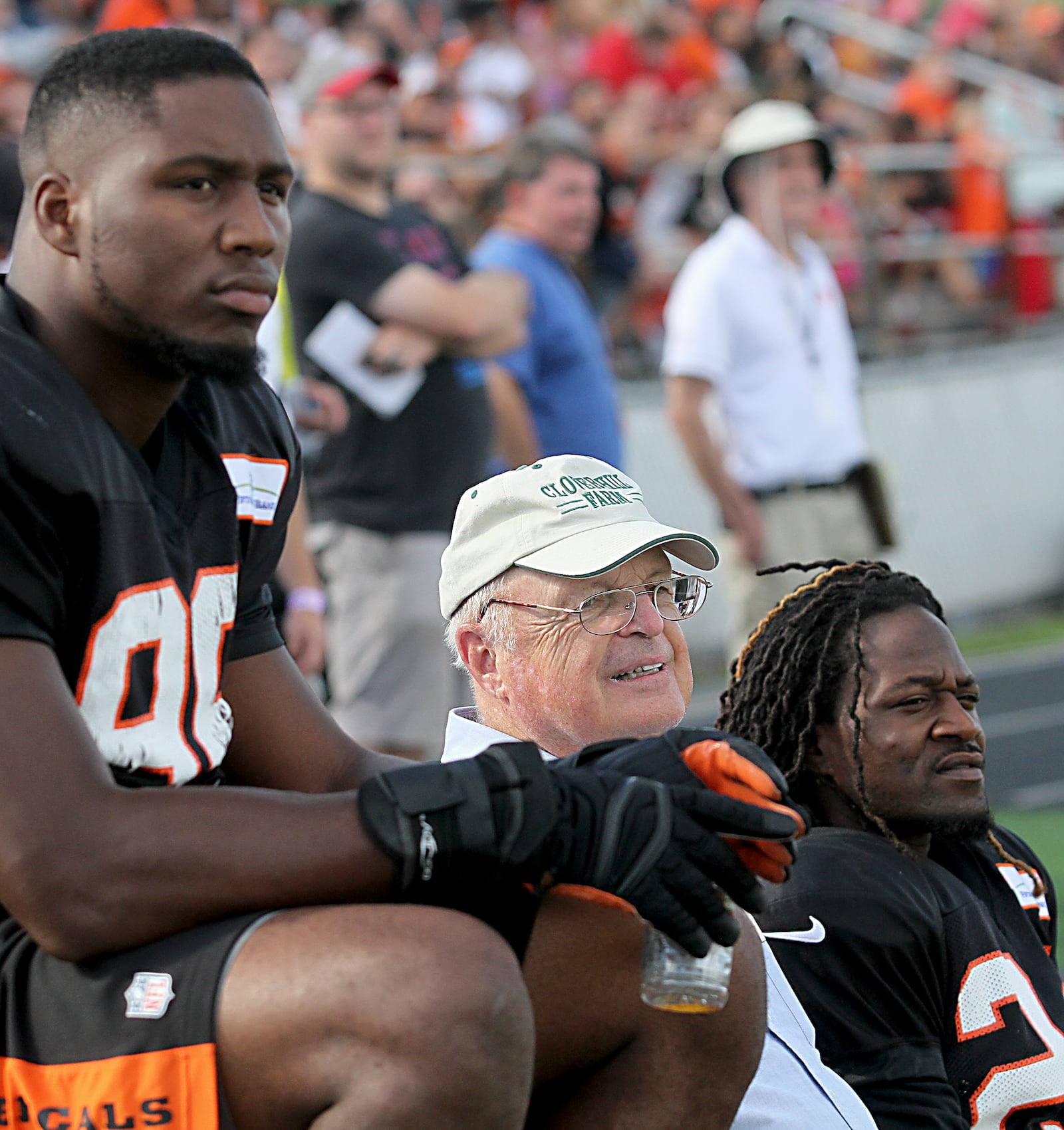 Contributed photo by E.L. Hubbard Bengals owner and president, Mike Brown, center, rides the bench between players Carlos Dunlap and Adam Jones during practice at West Carrollton High School Sunday, August 21, 2016.