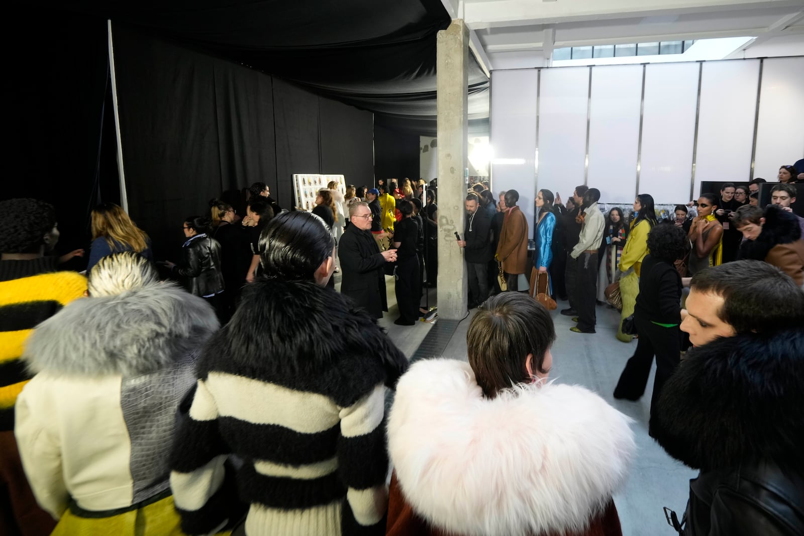 Models get ready in the backstage during the Marni Fall/Winter 2025-2026 Womenswear fashion show, during the Fashion Week, in Milan, Italy, Wednesday, Feb. 26, 2025. (AP Photo/Luca Bruno)