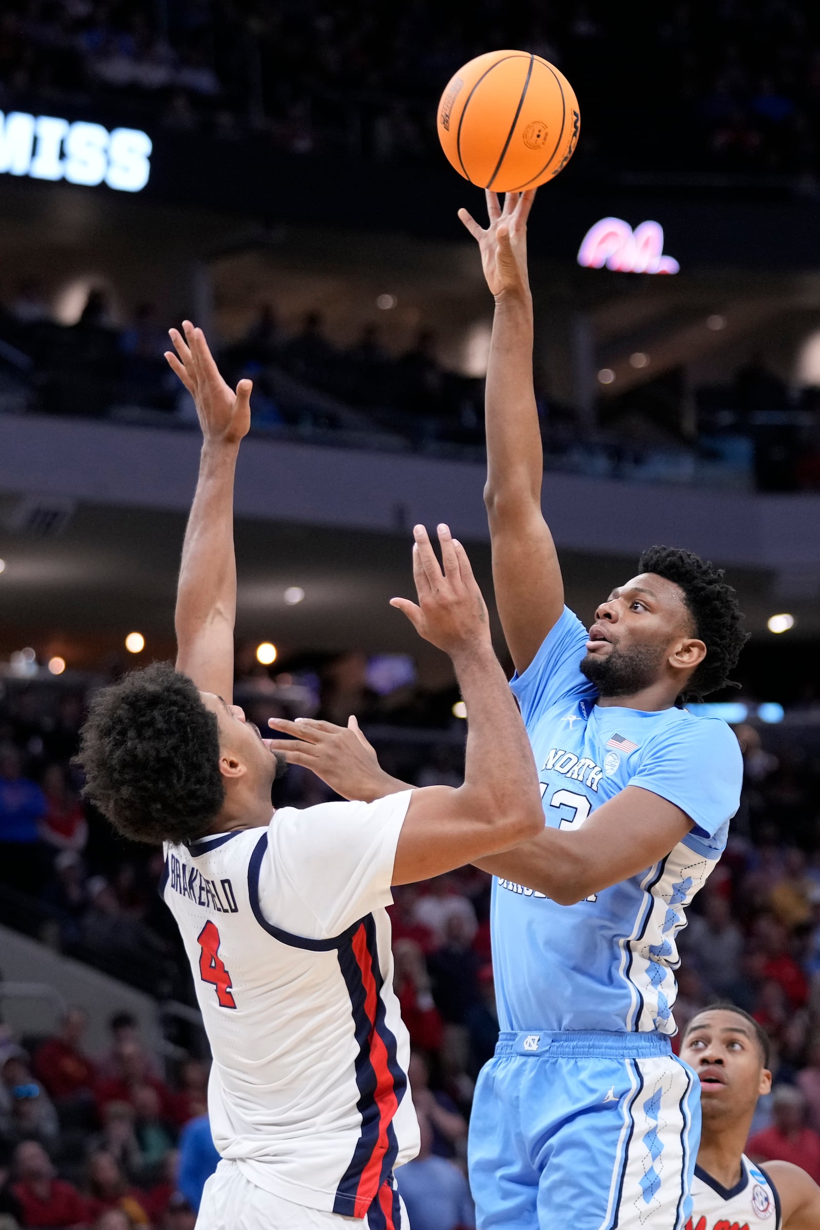 North Carolina forward Jalen Washington, front right, shoots to score against Mississippi forward Jaemyn Brakefield (4) during the second half in the first round of the NCAA college basketball tournament, Friday, March 21, 2025, in Milwaukee. (AP Photo/Kayla Wolf)