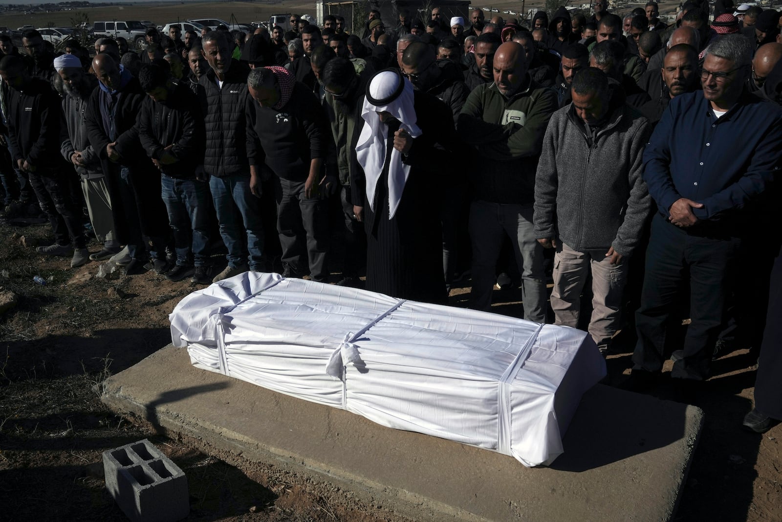 Members of the Bedouin community pray over the body of Yosef Al Zaydani, who was in Hamas captivity in the Gaza Strip, a day after the Israeli army said his body was recovered in an underground tunnel in southern Gaza, during his funeral in Rahat, southern Israel, Thursday, Jan. 9, 2025. (AP Photo/Mahmoud Illean)