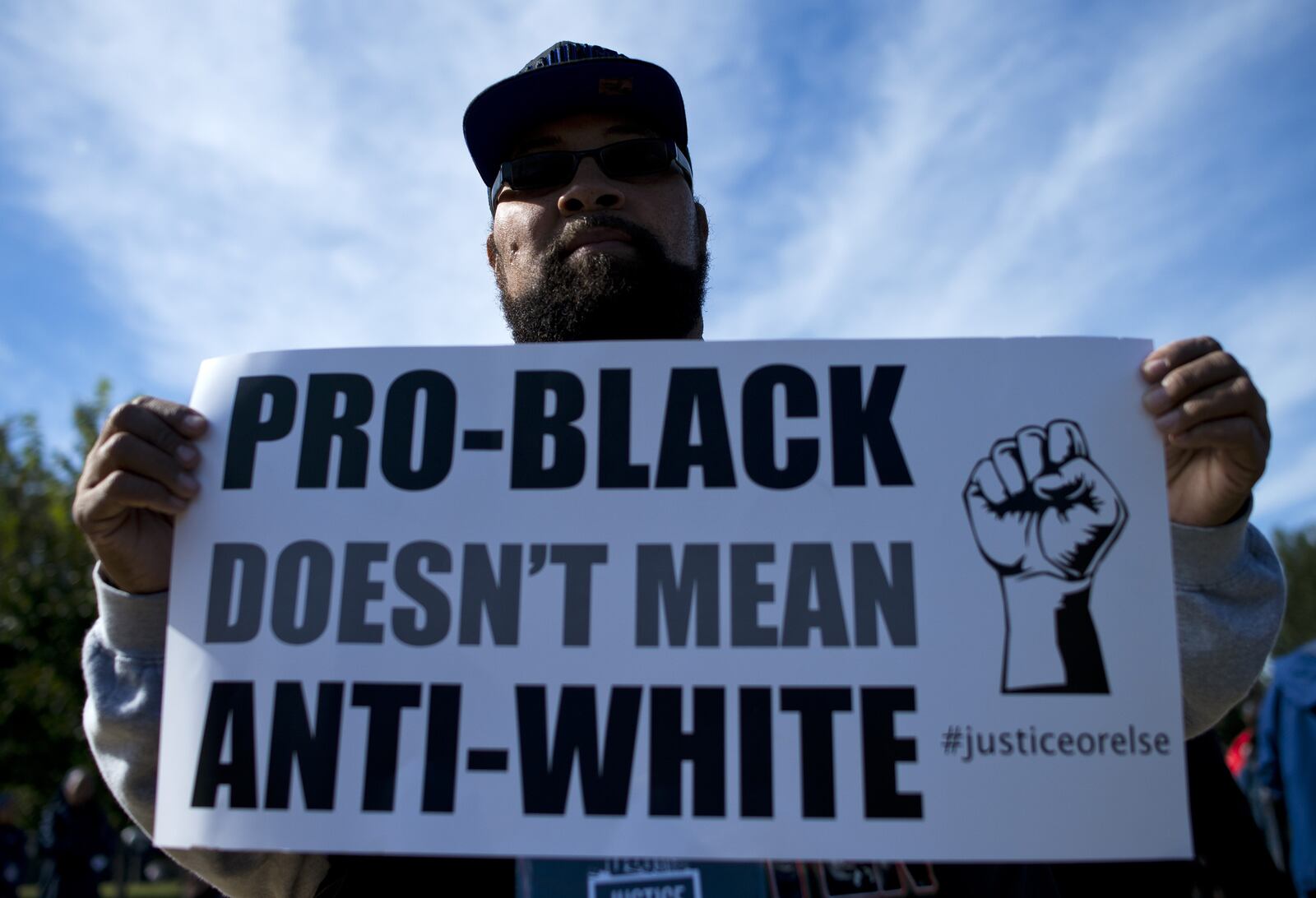 A protester holds up a sign during the Justice or Else! rally on the National Mall in Washington, DC on October 10, 2015. The rally commemorated the 20th anniversary of the Million Man March which took place on October 16, 1995. AFP PHOTO/ ANDREW CABALLERO-REYNOLDS (Photo credit should read Andrew Caballero-Reynolds/AFP/Getty Images)