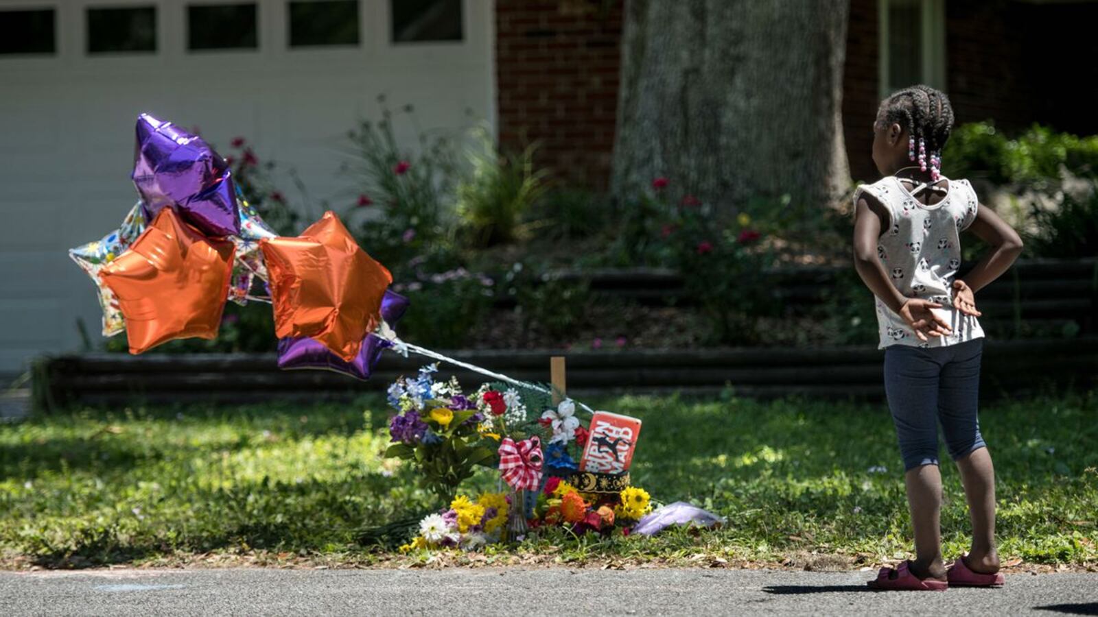 Former U.S. Marine Sgt. Sean Joseph provides armed protection for protesters in the Satilla Shores neighborhood as residents look on Friday, May 8, 2020, in Brunswick, Ga. Travis McMichaels, 34, and his father, 64-year-old Gregory McMichaels, are charged with felony murder and aggravated assault in the Feb. 23 shooting of Ahmaud Arbery, who was jogging in the predominantly white neighborhood. (Sean Rayford/Getty Images)