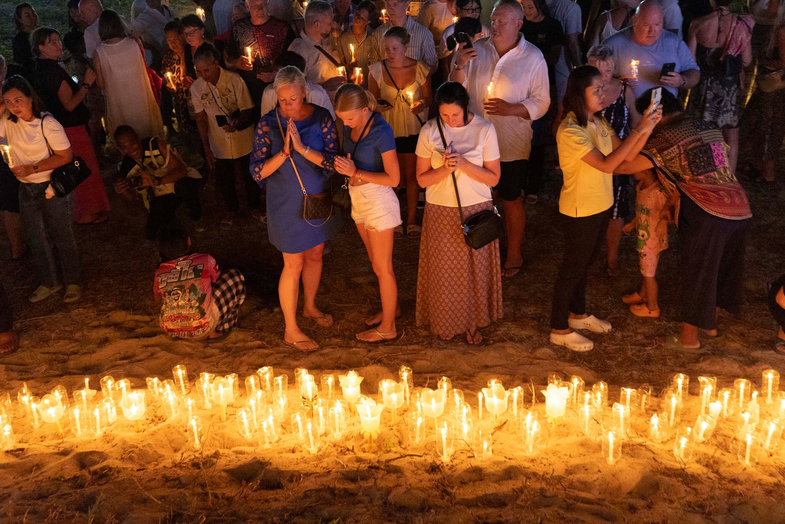 Relatives of victims of the 2004 Indian Ocean tsunami hold a candle light vigil as they participate in the 20th anniversary, at Tsunami Memorial Park at Ban Nam Khem, Takuapa district of Phang Nga province, southern Thailand, Thursday, Dec. 26, 2024. (AP Photo/Wason Wanichakorn)