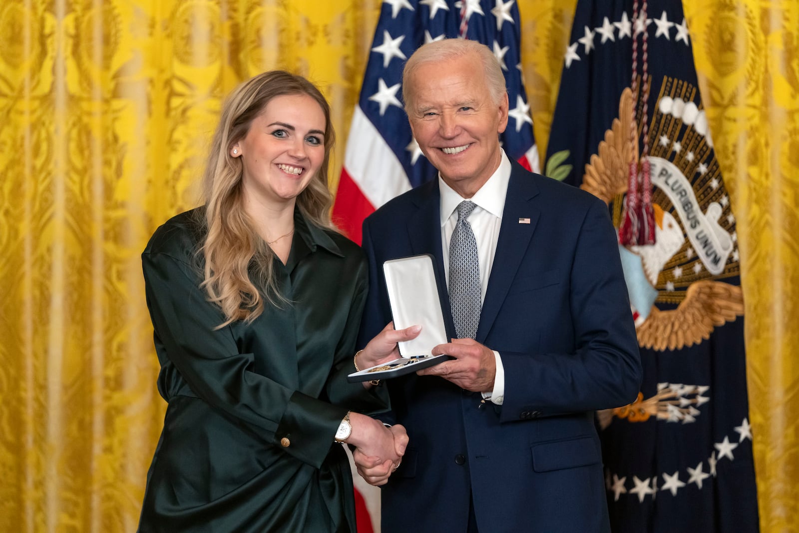 President Joe Biden awards the Presidential Citizens Medal to Grace McCarthy on behalf of Carolyn McCarthy during a ceremony in the East Room at the White House, Thursday, Jan. 2, 2025, in Washington. (AP Photo/Mark Schiefelbein)