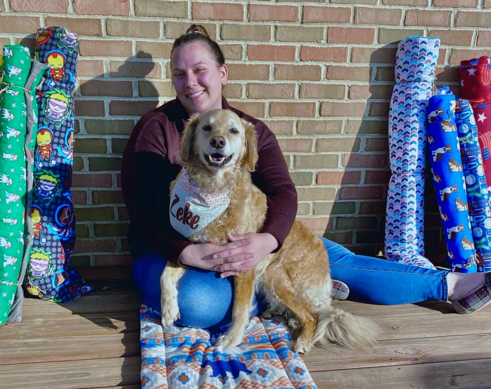 Stephanie and Zeke sitting comfortably on a pet mat. PROVIDED