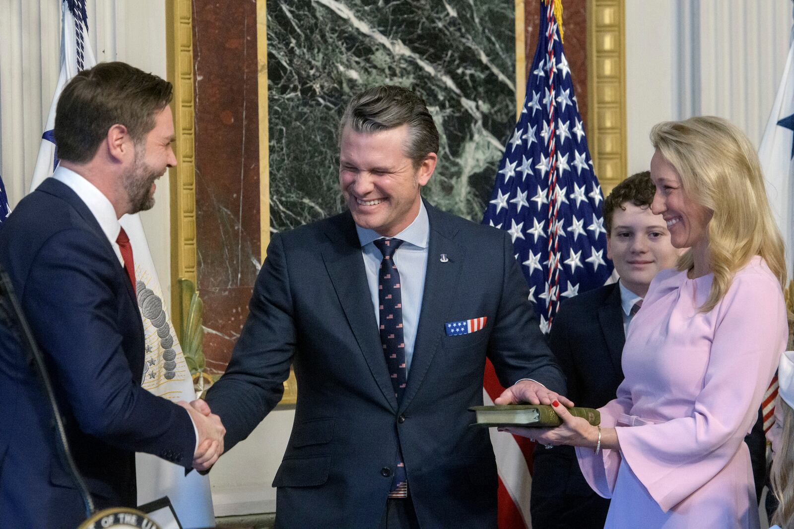 Vice President JD Vance, from left, swears in Pete Hegseth to be Secretary of Defense as his wife Jennifer Rauchet holds the Bible and Hegseth's son watches in the Indian Treaty Room of the Eisenhower Executive Office Building on the White House campus in Washington, Saturday, Jan. 25, 2025. (AP Photo/Rod Lamkey, Jr.)