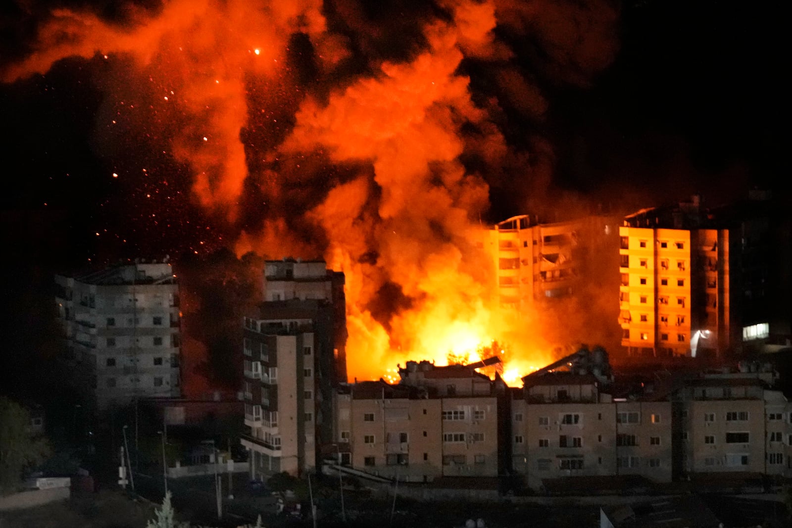 Flame and smokes rise from buildings hit by Israeli airstrikes on Dahiyeh, in the southern suburb of Beirut,, Wednesday, Oct. 23, 2024. (AP Photo/Hussein Malla)