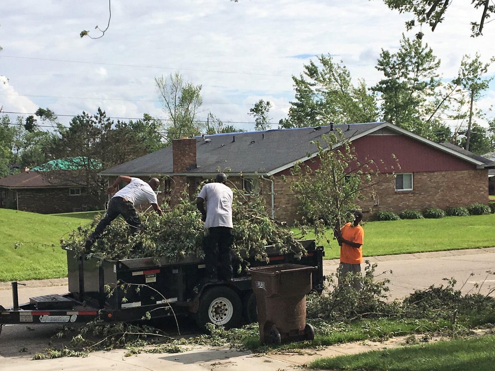 Volunteers help clear debris from yards in Trotwood on Thursday May 30, 2019. KATIE WEDELL/STAFF