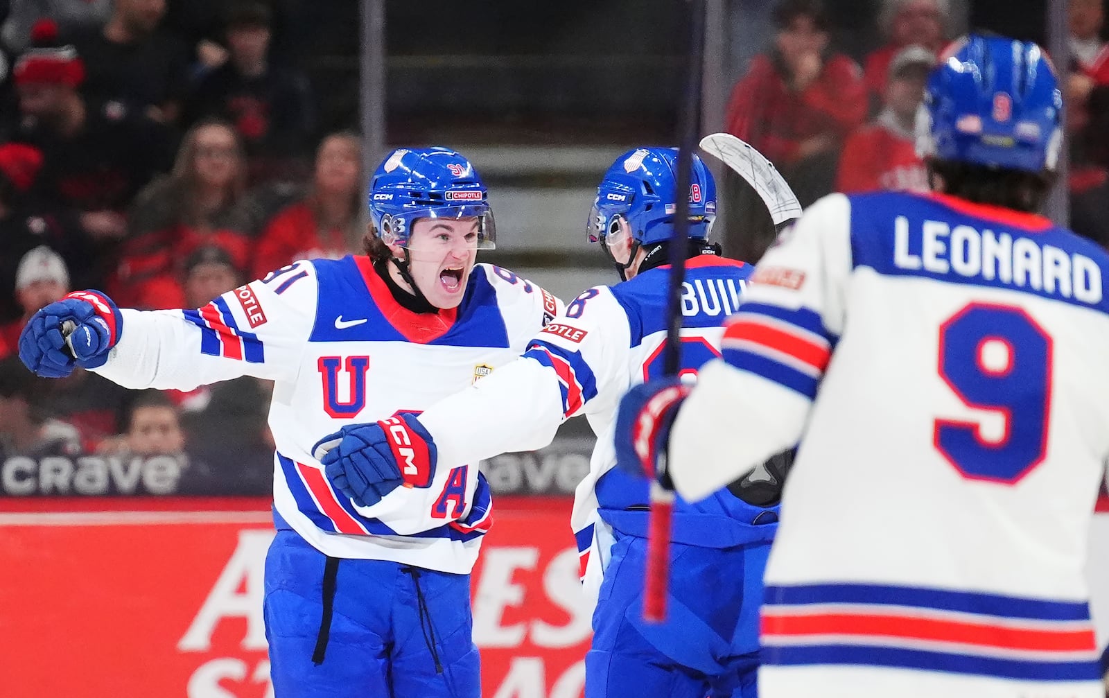 United States' Cole Eiserman (91) celebrates his goal against Canada with Zeev Buium (28) during the third period of an IIHF World Junior Hockey Championship tournament game in Ottawa, Ontario on Tuesday, Dec. 31, 2024. (Sean Kilpatrick/The Canadian Press via AP)