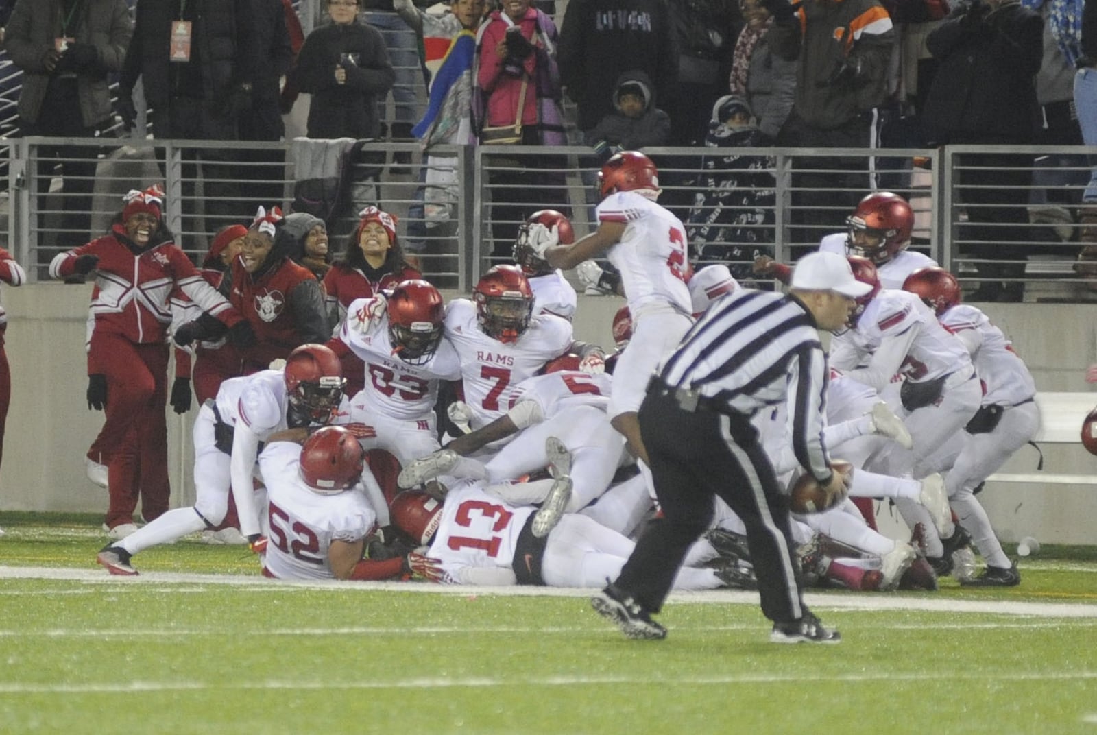 Trotwood’s Jayvanare Nelloms (bottom) and the Rams celebrate his goal-line, title-clinching INT in the final seconds. Trotwood-Madison defeated Dresden Tri-Valley 27-19 to win a D-III high school football state title at Canton on Sat., Dec. 2, 2017. MARC PENDLETON / STAFF