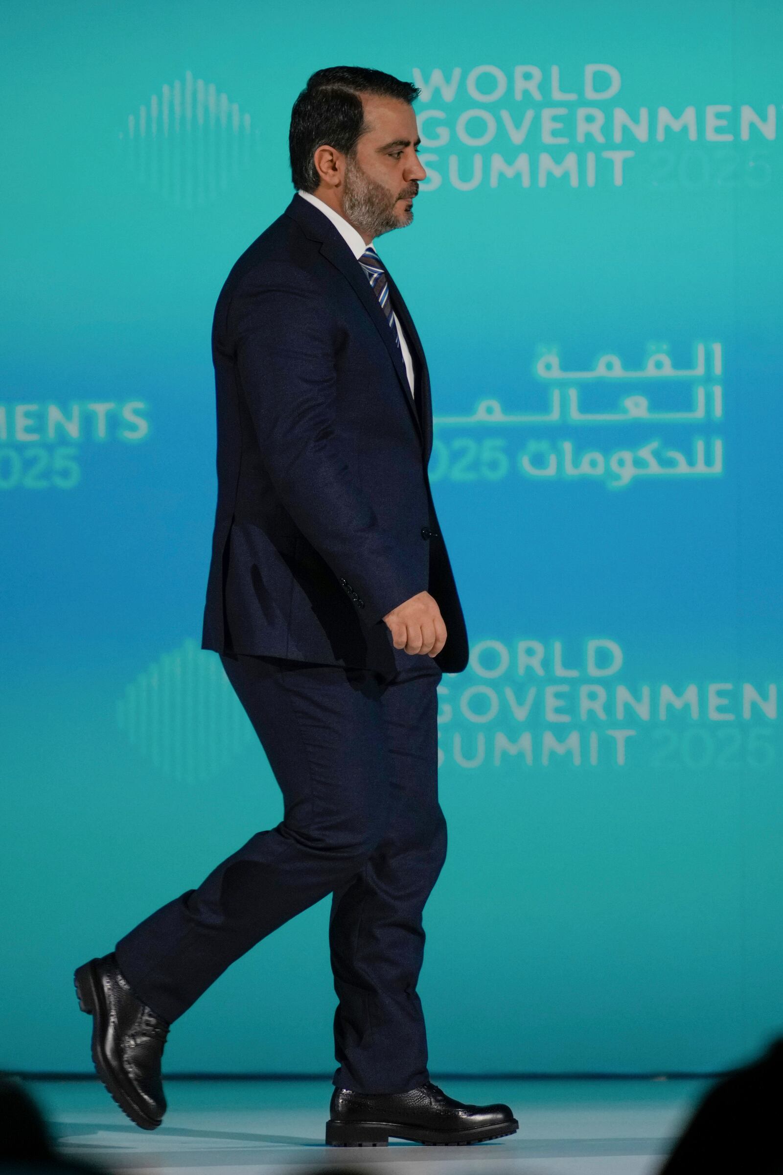 Syria's Interim Foreign Minister Asaad al-Shibani arrives on the stage for a talk with Kuwaiti journalist Ammar Taqi during the World Governments Summit in Dubai, United Arab Emirates, Wednesday, Feb. 12, 2025. (AP Photo/Altaf Qadri)