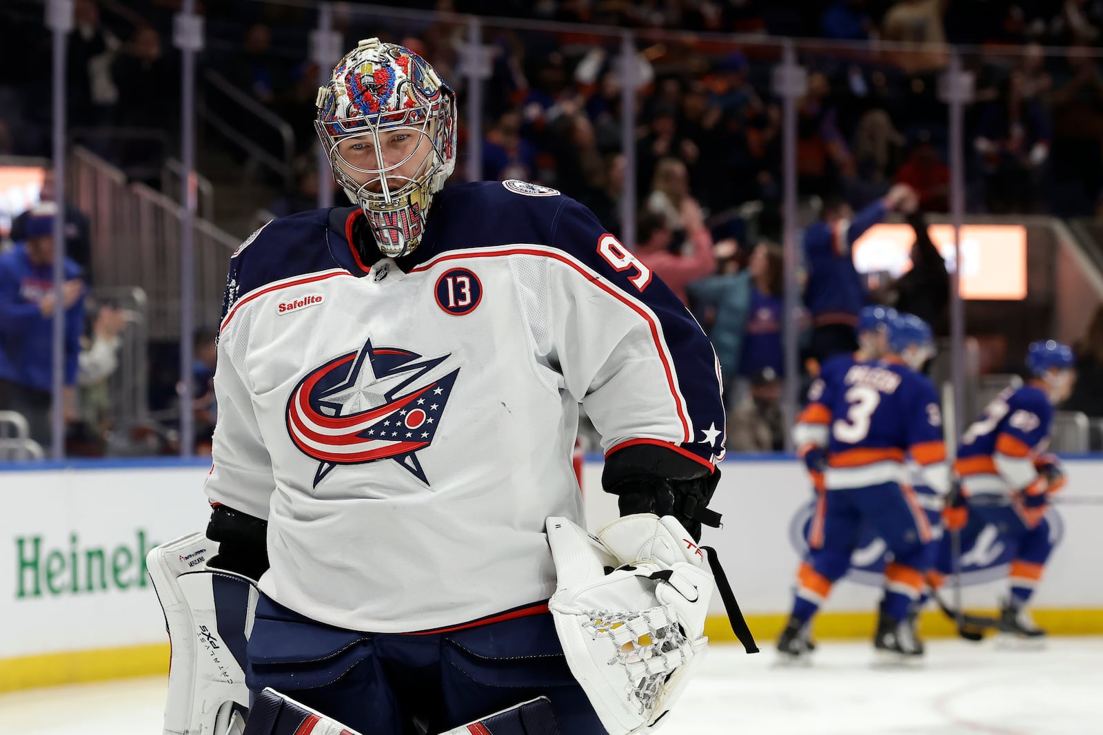 Columbus Blue Jackets goaltender Elvis Merzlikins, left, reacts after giving up a goal to New York Islanders center Bo Horvat in the second period of an NHL hockey game Monday, Jan. 20, 2025, in Elmont, N.Y. (AP Photo/Adam Hunger)