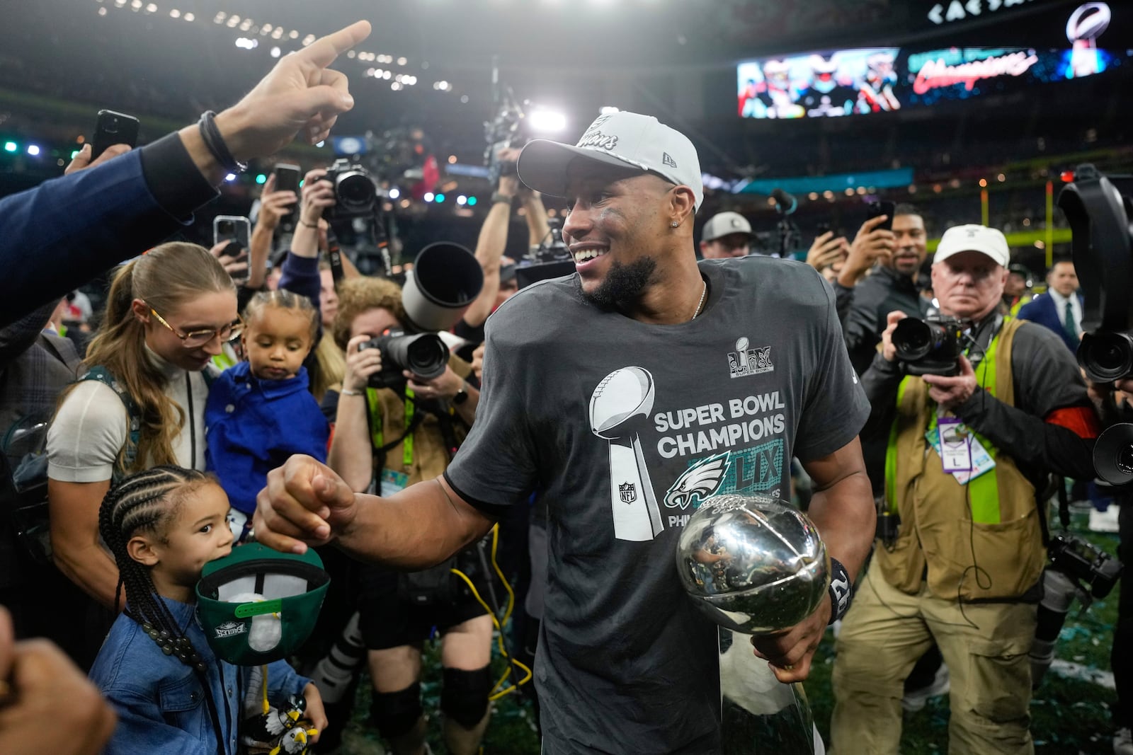 Philadelphia Eagles running back Saquon Barkley celebrates with the Vince Lombardi Trophy after a win over the Kansas City Chiefs in the NFL Super Bowl 59 football game, Sunday, Feb. 9, 2025, in New Orleans. (AP Photo/Matt Slocum)