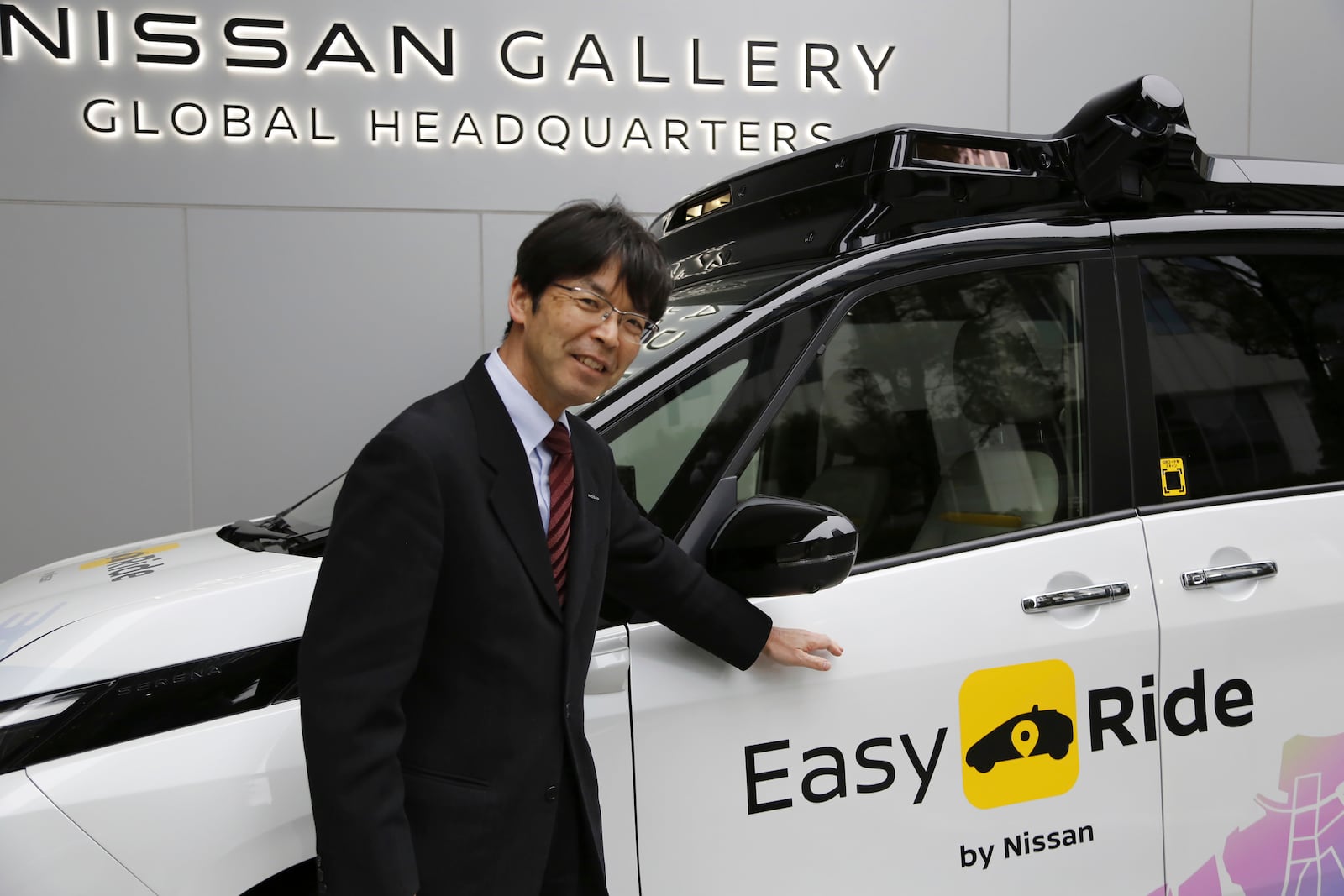 Takeshi Kimura, a Nissan engineer overseeing the Japanese automaker’s self-driving technology, shows the car packed with the technology to reporters at Nissan headquarters in Yokohama, near Tokyo, on March 6, 2025. (AP Photo/Yuri Kageyama)