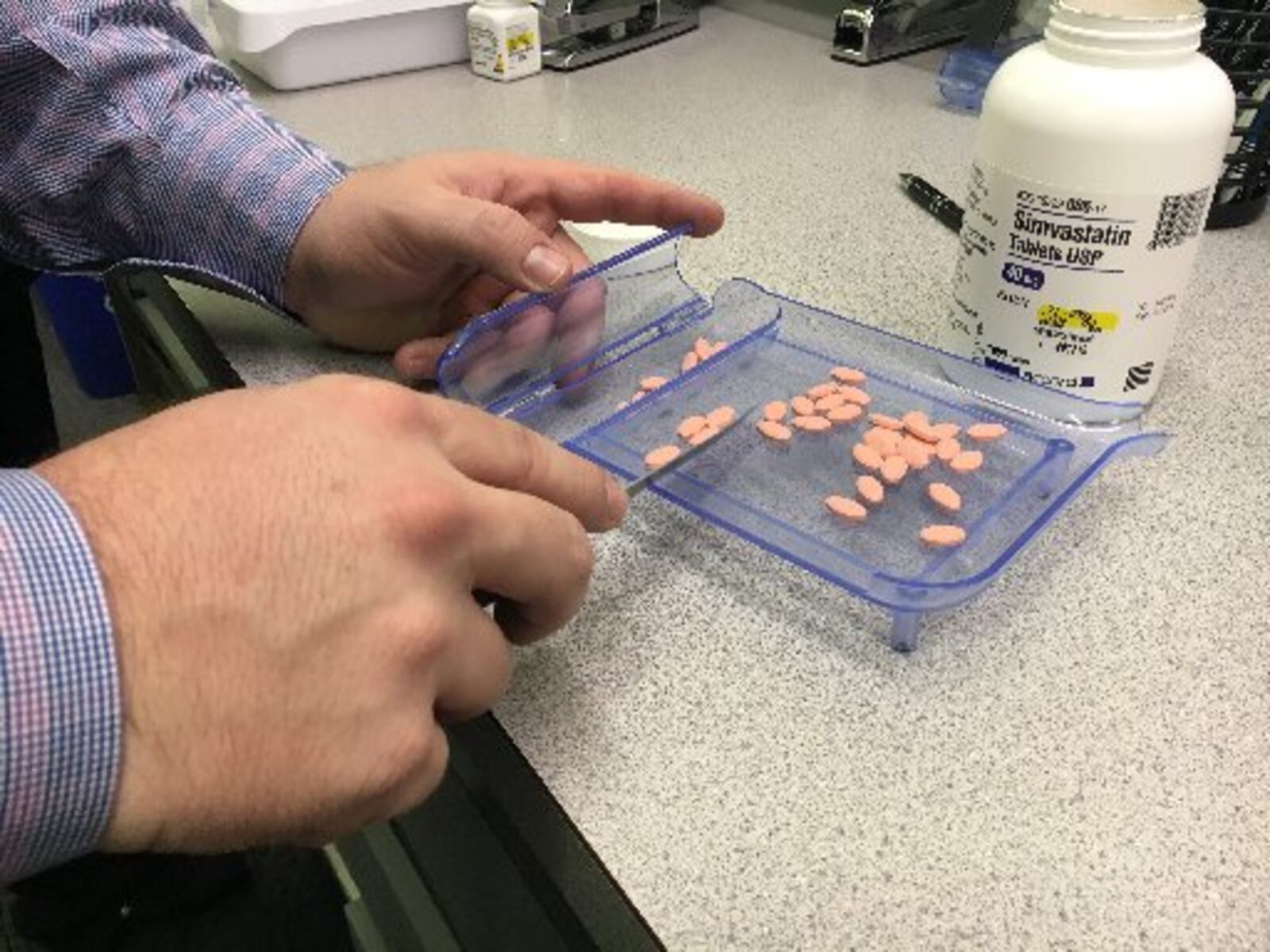 Pharmacist Kyle Fields counts pills at Waynesville Pharmacy, Dec. 2, 2016. The Dayton Daily News has been digging into the complex system behind how prescription drugs get priced. KATIE WEDELL/STAFF