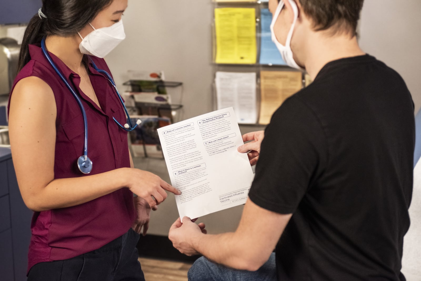 In this 2020 photograph, captured inside a clinical setting, a health care provider and patient, consult on influenza vaccine options. The best way to prevent seasonal flu illness, is to get vaccinated every year. Centers for Disease Control and Prevention (CDC) recommends everyone 6-months of age and older get a flu vaccine every season. COURTESY OF CDC