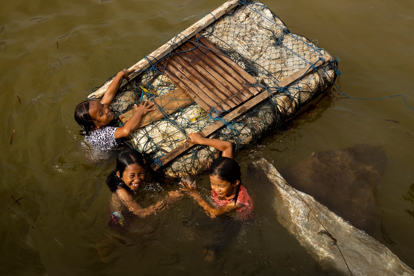 Children play in the water on Kabaena Island in South Sulawesi, Indonesia, Friday, Nov. 15, 2024. (AP Photo/Yusuf Wahil)