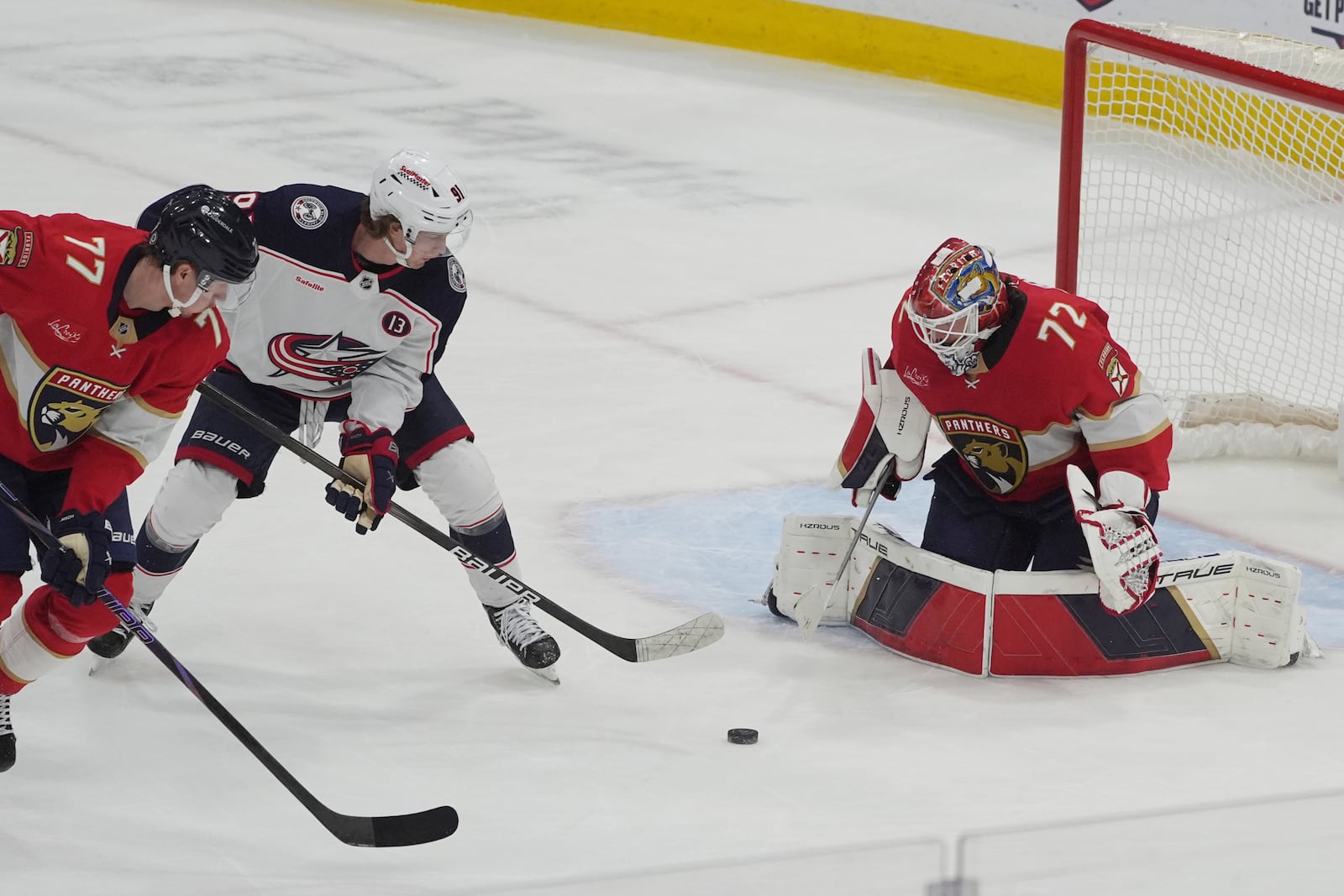 Florida Panthers goaltender Sergei Bobrovsky (72) stops a shot by Columbus Blue Jackets center Kent Johnson (91) during the first period of an NHL hockey game, Thursday, March 6, 2025, in Sunrise, Fla. (AP Photo/Marta Lavandier)