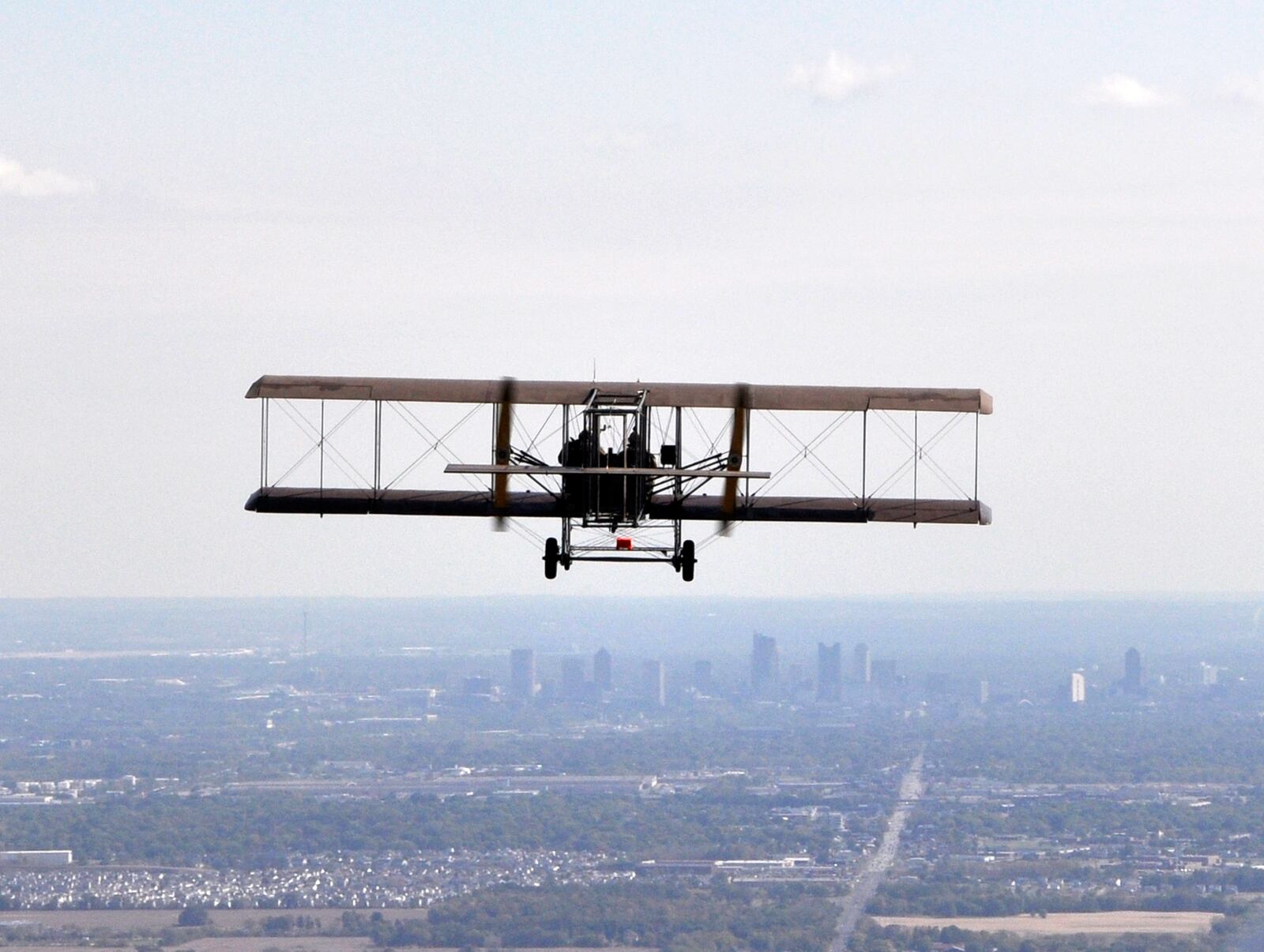 On October 2, 2010, Wright-Patterson Air Force Base celebrated the centennial of the first cargo flight through a reenactment.  Pictured above, a lookalike Wright “B” Flyer approaches Columbus, OH.