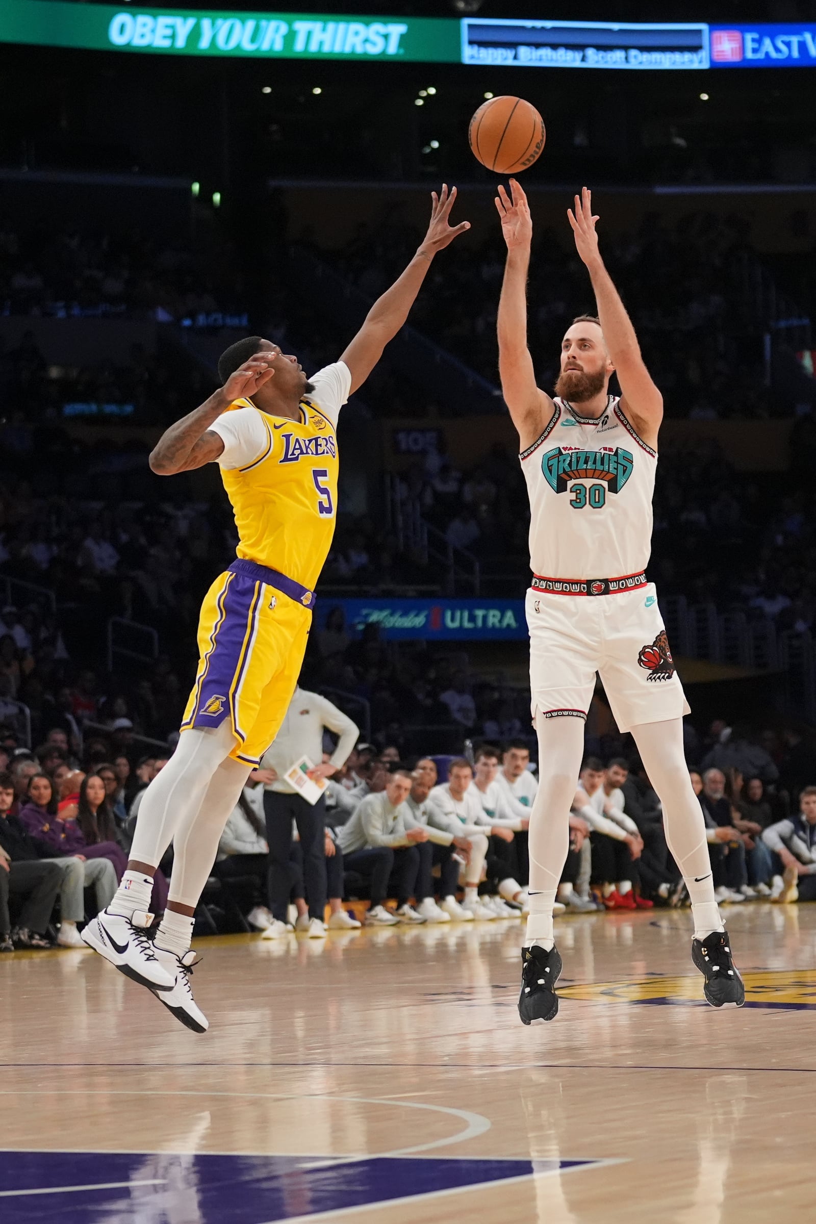 Memphis Grizzlies center Jay Huff (30) shoots over Los Angeles Lakers forward Cam Reddish (5) during the first half of an NBA basketball game Wednesday, Nov. 13, 2024, in Los Angeles. (AP Photo/Marcio Jose Sanchez)