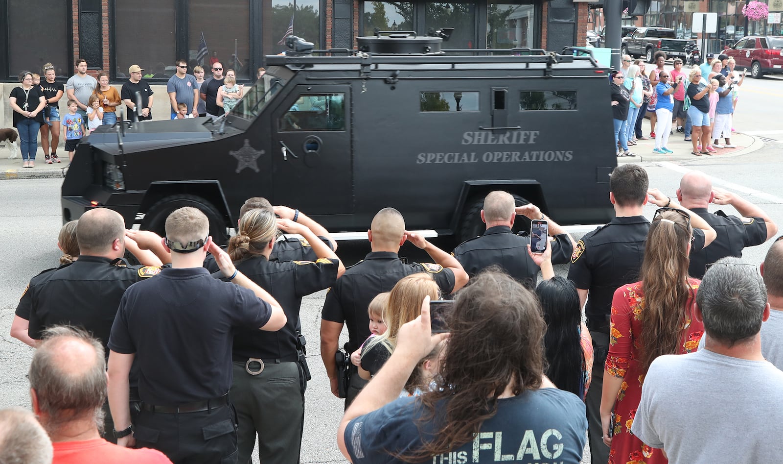 The Clark County community showed up to pay their respect to Deputy Matthew Yates who's body returned to Springfield in a Sheriff's Special Operations vehicle Monday afternoon. Yates, was escorted by a procession of law enforcement vehicles. Yates was shot Sunday while responding to a call at Harmony Estates mobile home park. BILL LACKEY/STAFF