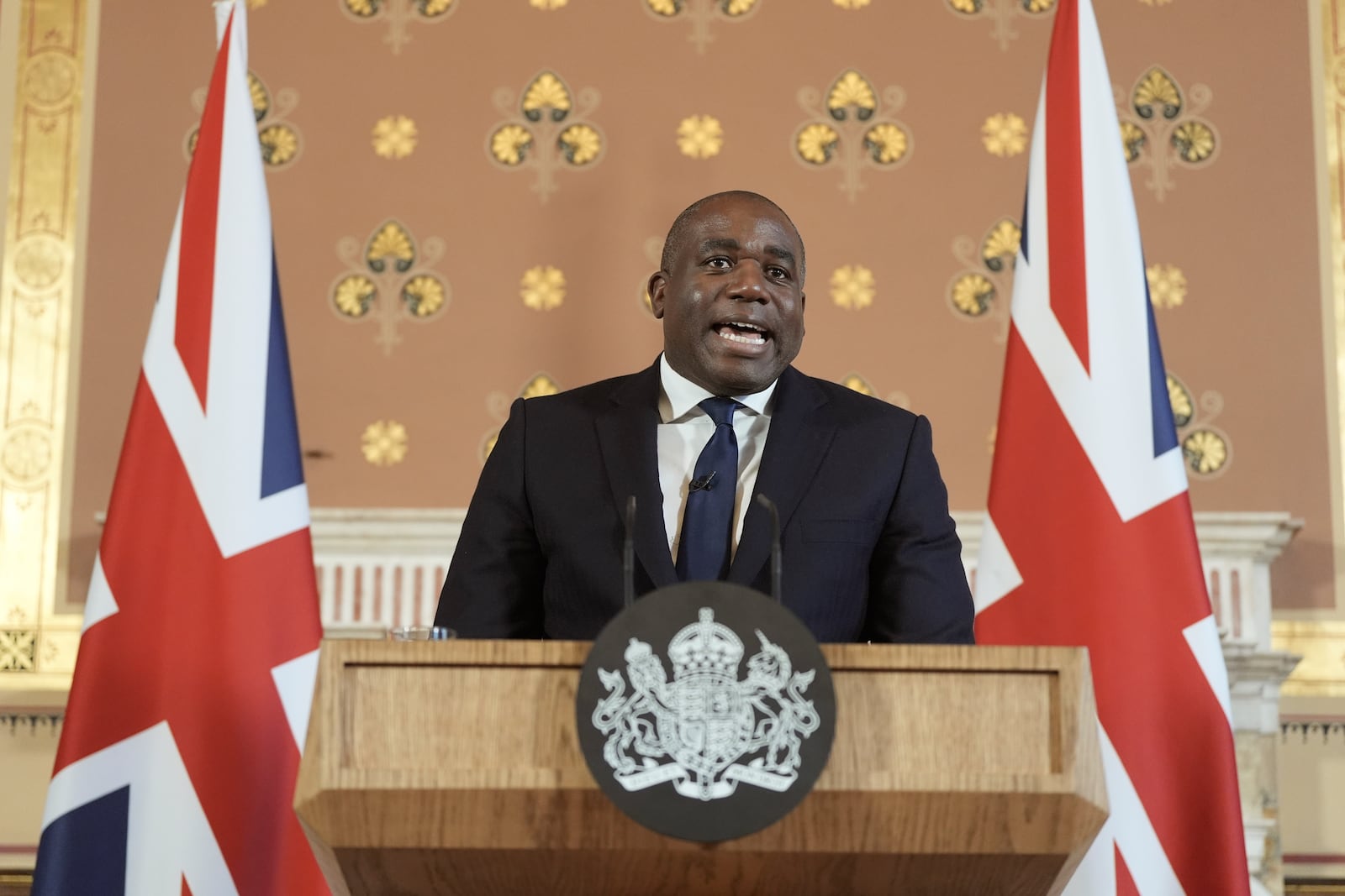 Britain's Foreign Secretary David Lammy delivers a speech on the government plans for new sanctions which will target the finances of people smuggling networks as part of efforts to stop migrants crossing the English Channel, in London, Thursday, Jan. 9, 2025. (Stefan Rousseau/Pool Photo via AP)