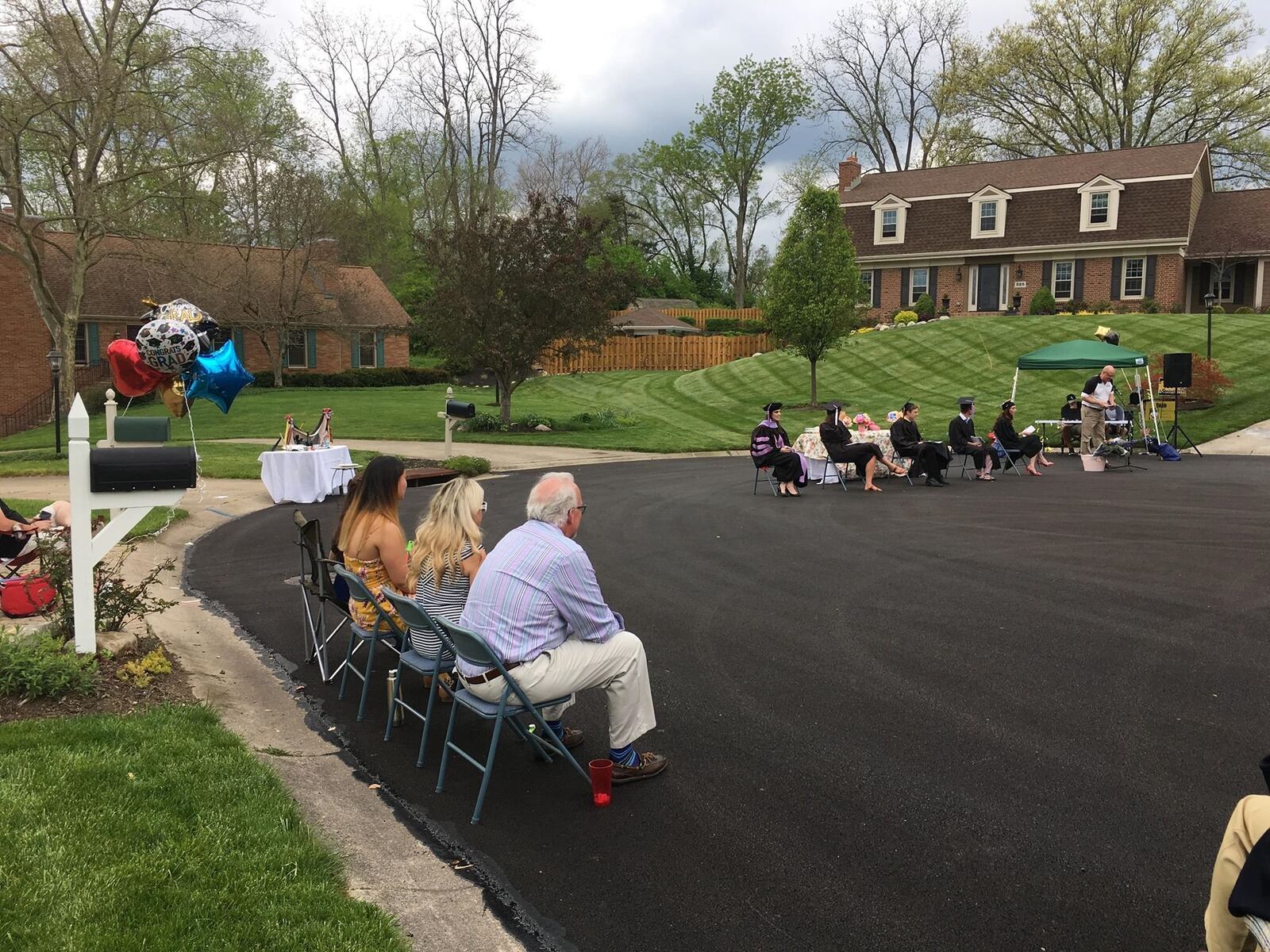 Neighbors of Southbridge Lane in Washington Twp. gathered for a graduation ceremony of 5 graduates who live on the street on Saturday, May 16, 2020. Staff Photo / Sarah Franks