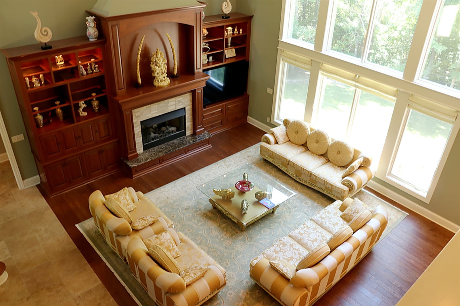 A 2-story foyer flows into a great room with a wall of mahogany built-ins that surround a gas fireplace. A wall of windows provides views of the 1-acre property that has a fenced, manicured lawn, stone-lined gardens and thick, mature tree line. CONTRIBUTED PHOTO BY KATHY TYLER