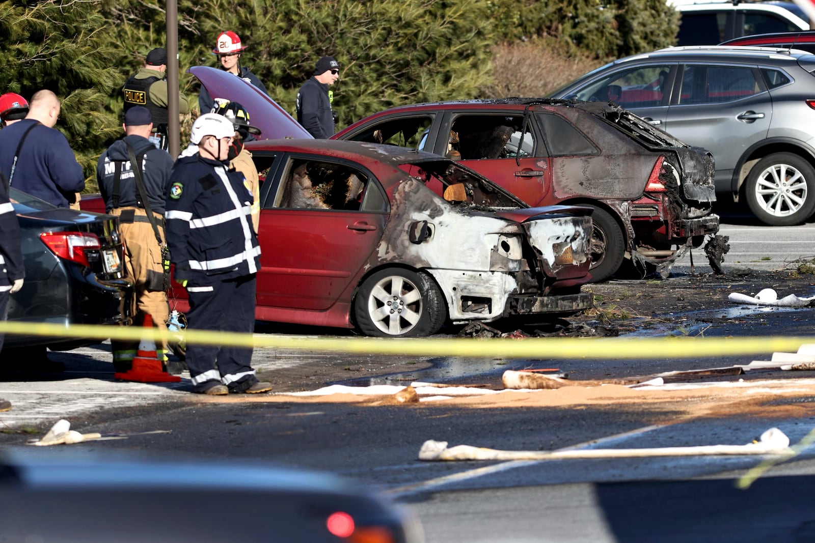 First responders work the scene after a plane crashed in a parking lot of a retirement community Sunday, March 9, 2025, in Manheim Township, Pa. (Zach Gleiter/The Patriot-News via AP)